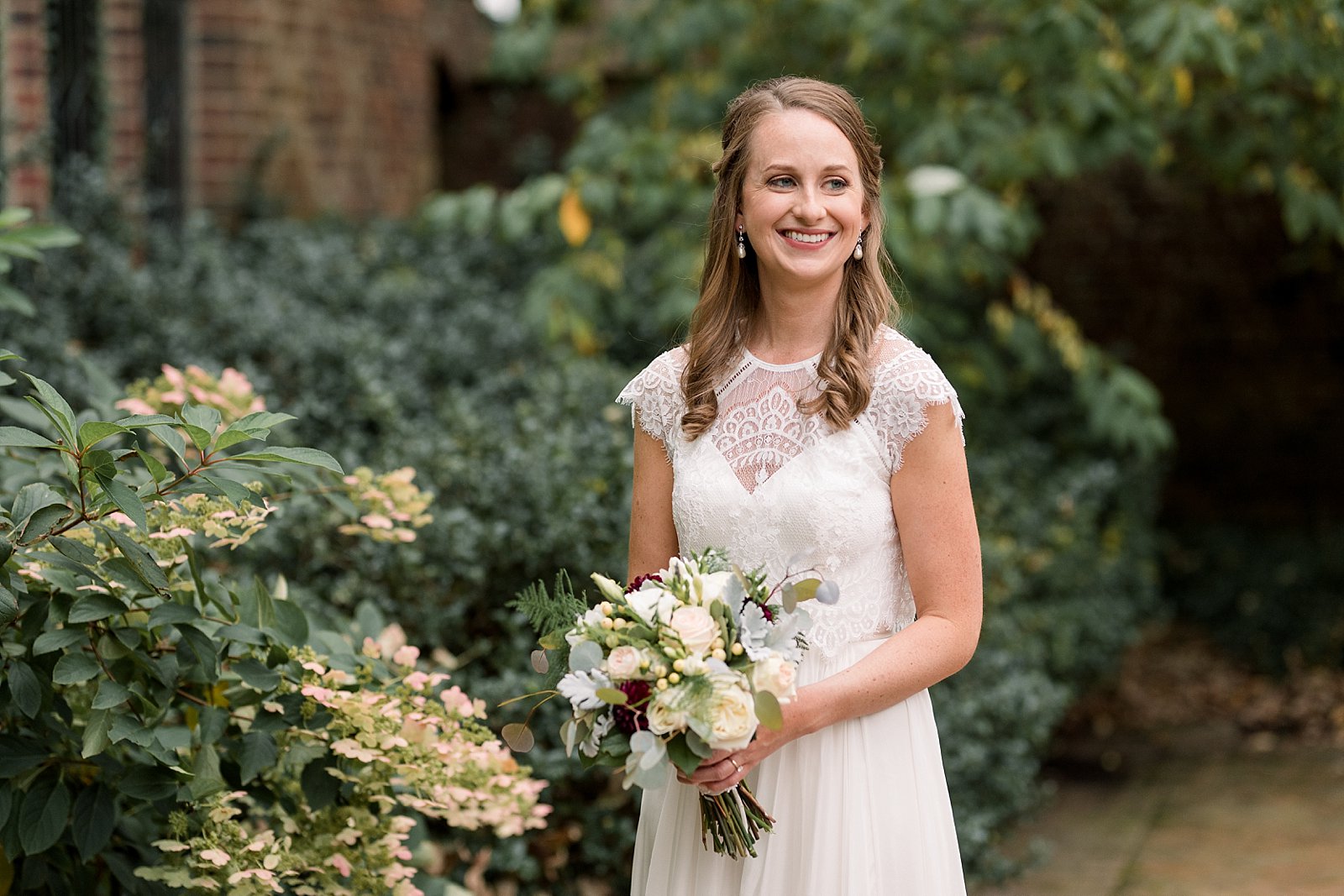 bride in wedding dress with lace top at Aldie Mansion