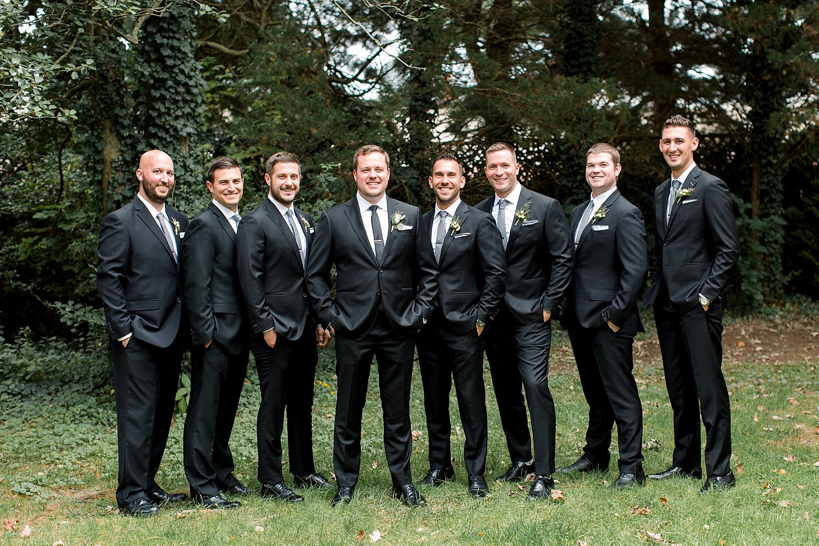 groom and groomsmen stand on lawn at Aldie Mansion