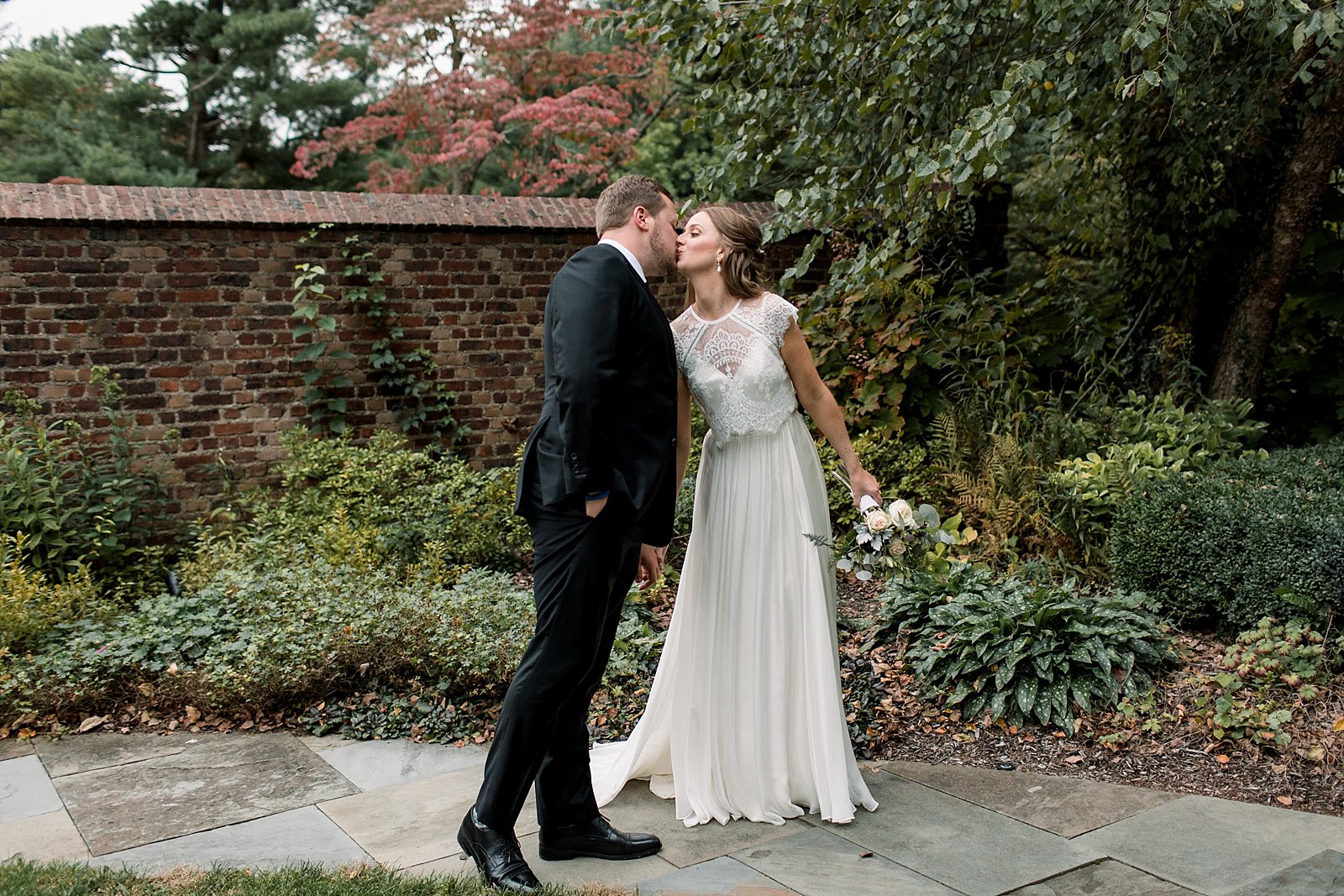 bride and groom kiss in garden at Aldie Mansion