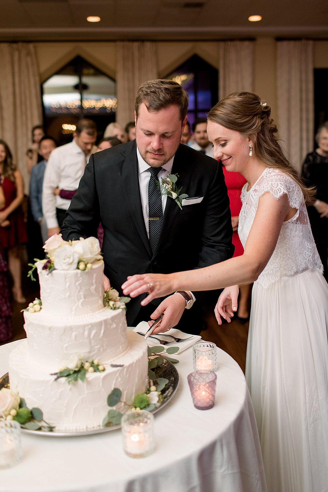 newlyweds cut wedding cake during Aldie Mansion wedding reception