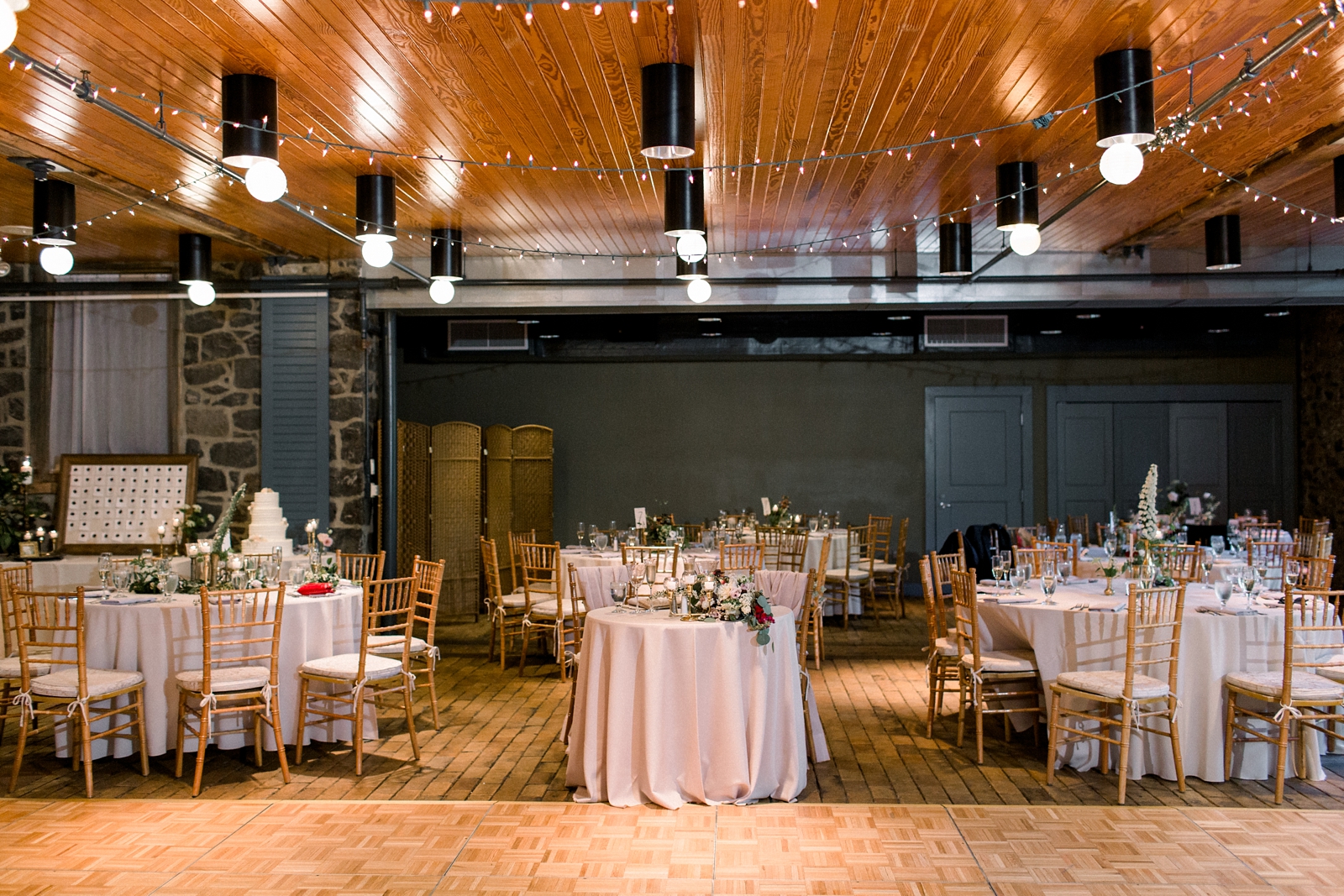 The Carriage House at Rockwood Park wedding reception with gold chivari chairs 