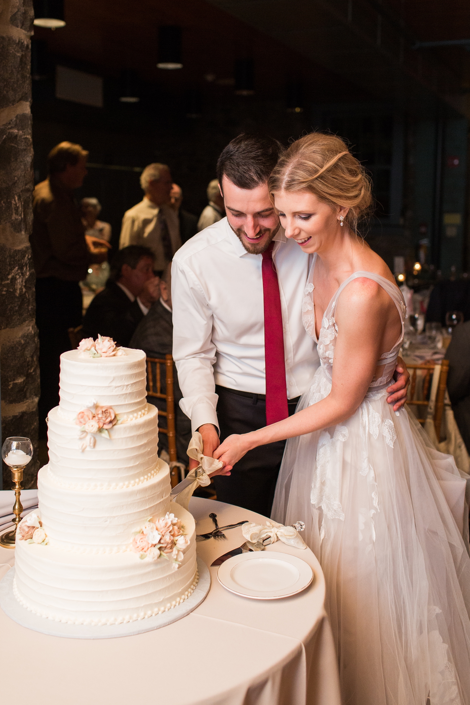 bride and groom cut wedding cake at The Carriage House at Rockwood Park wedding reception