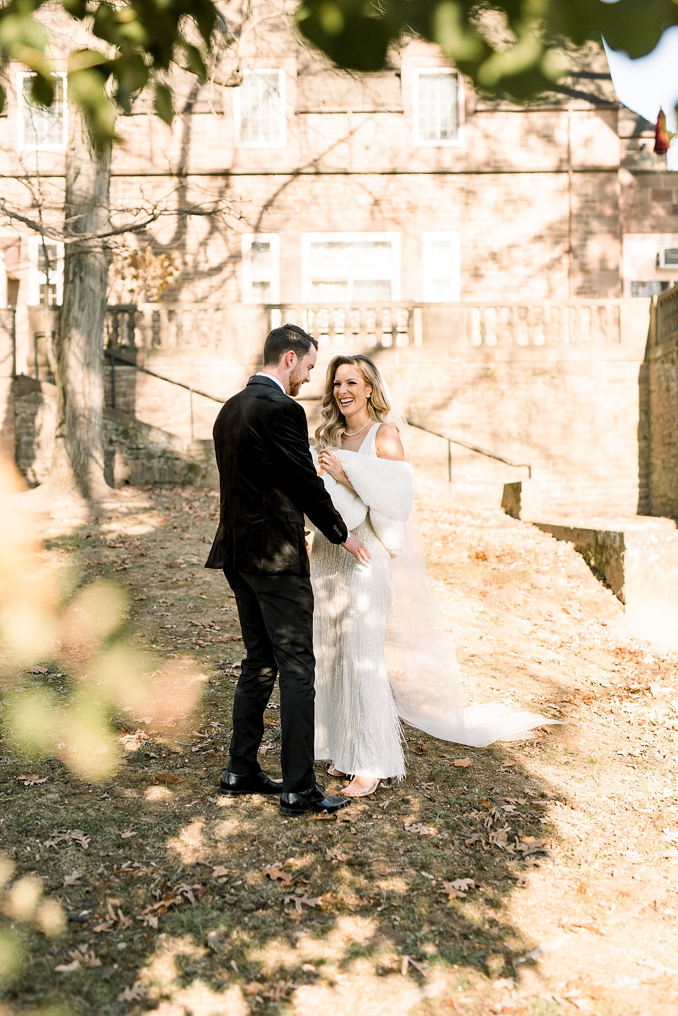 bride and groom laugh in courtyard at Tyler Gardens 