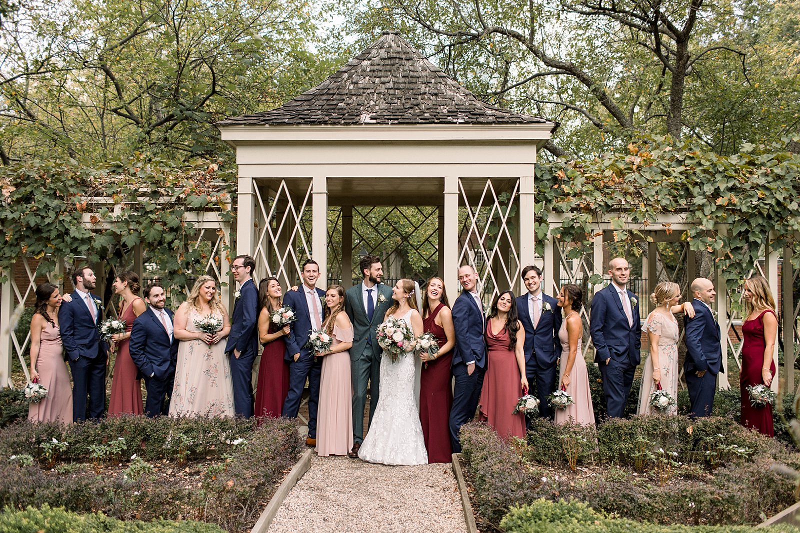 newlyweds pose with wedding party in front of gazebo at the Merchant’s Exchange Building
