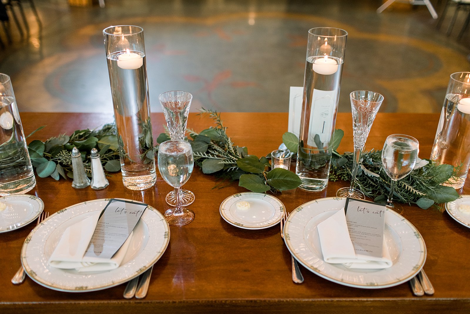 wedding reception with floating candles and greenery at Knowlton Mansion
