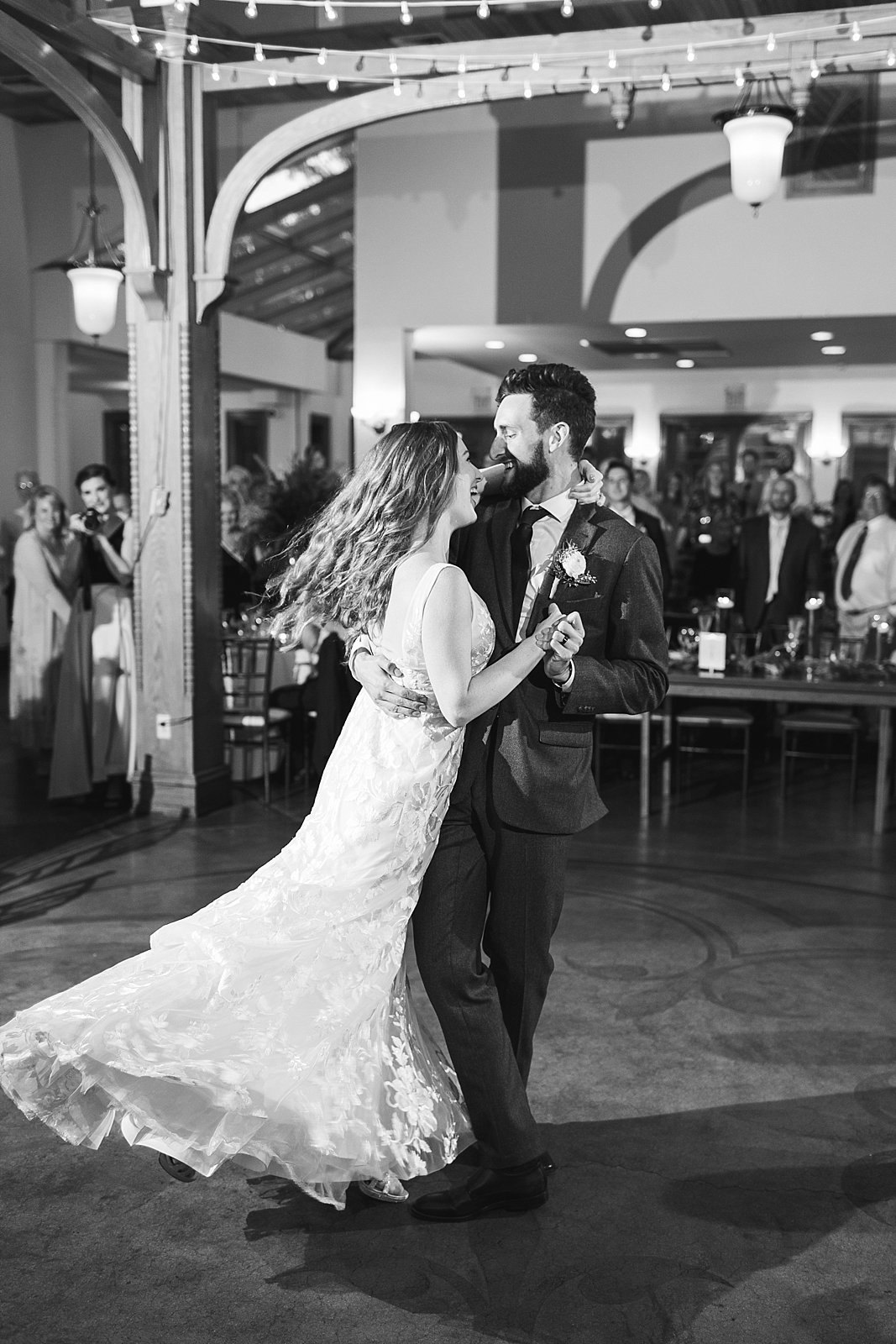 groom twirls bride on dance floor at Knowlton Mansion