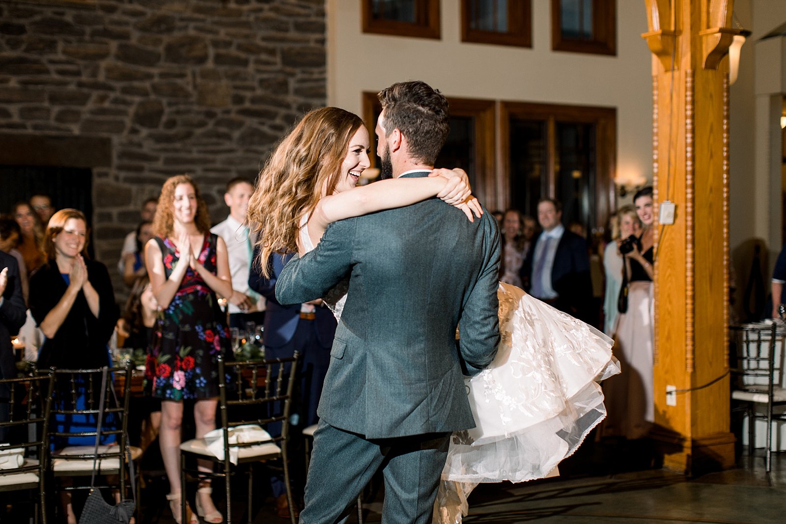 groom lifts bride up during first dance at Knowlton Mansion