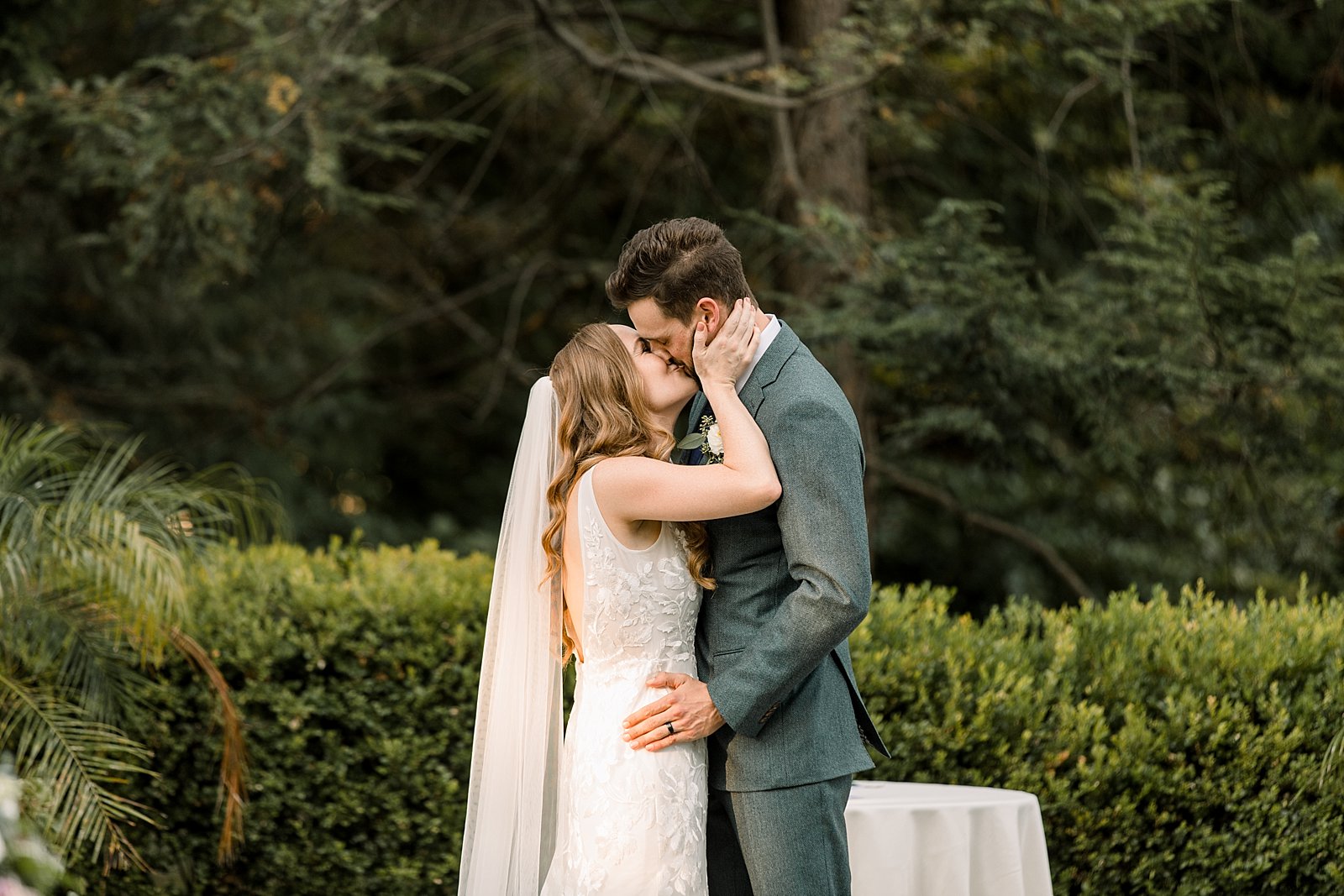 newlyweds kiss after Knowlton Mansion wedding ceremony on the lawn