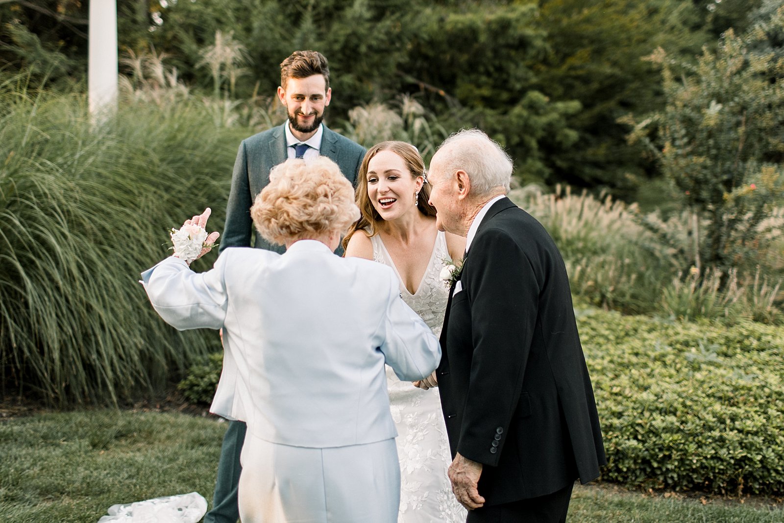grandparents greet bride and groom during cocktail hour at Knowlton Mansion