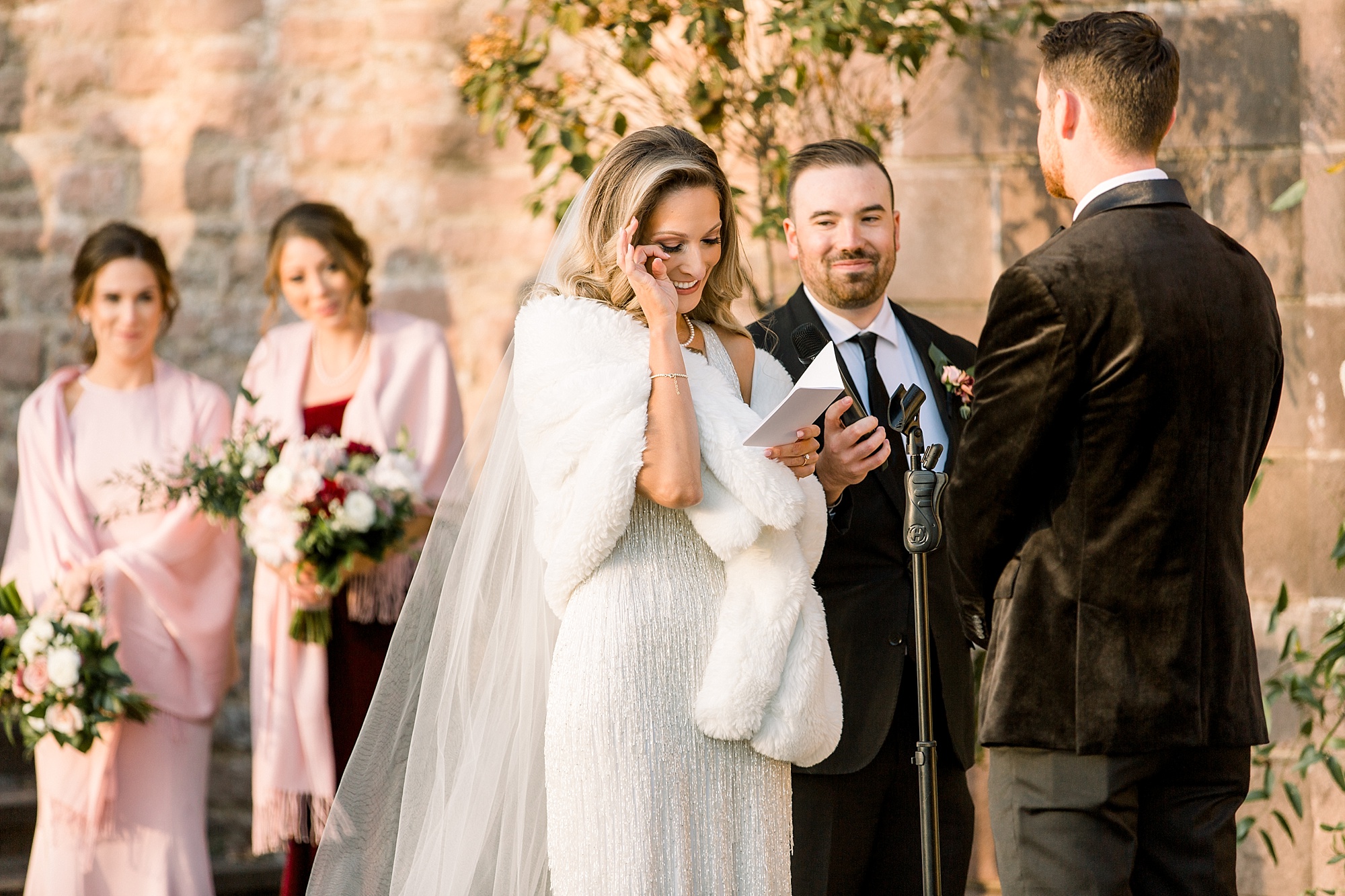 bride cries reading vows during Tyler Gardens wedding ceremony in courtyard