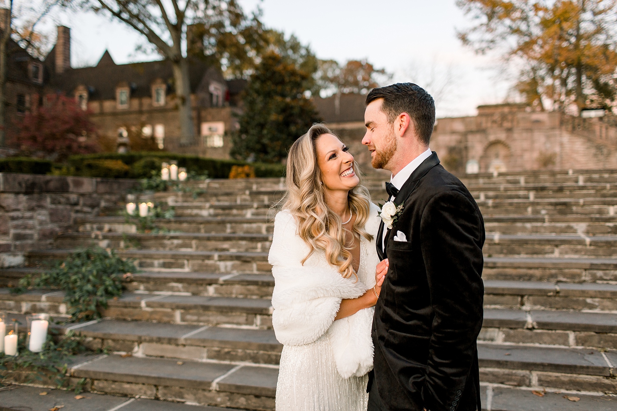 bride and groom hug on steps during winter wedding photos at Tyler Gardens 