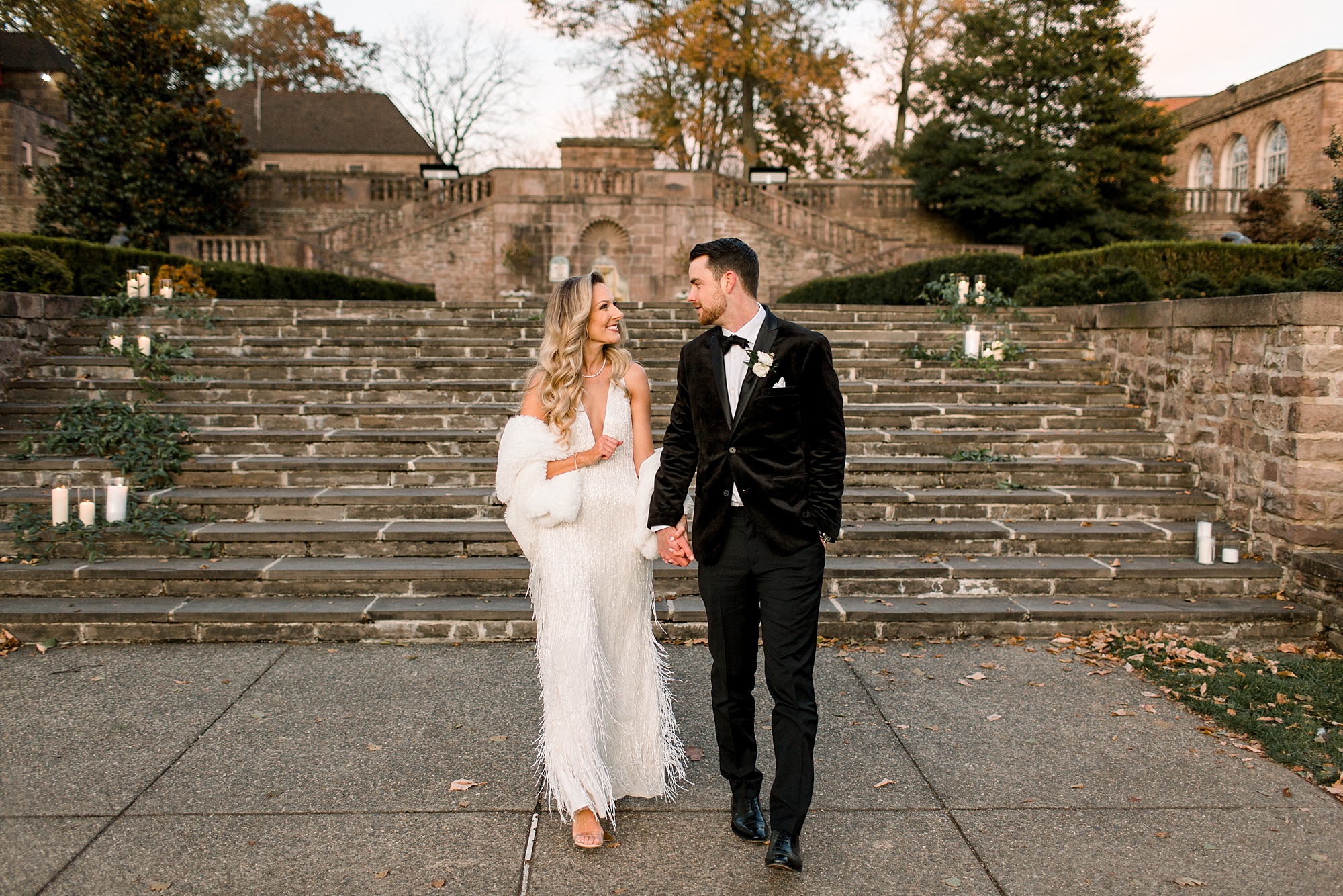 bride and groom hold hands walking away from steps at Tyler Gardens 