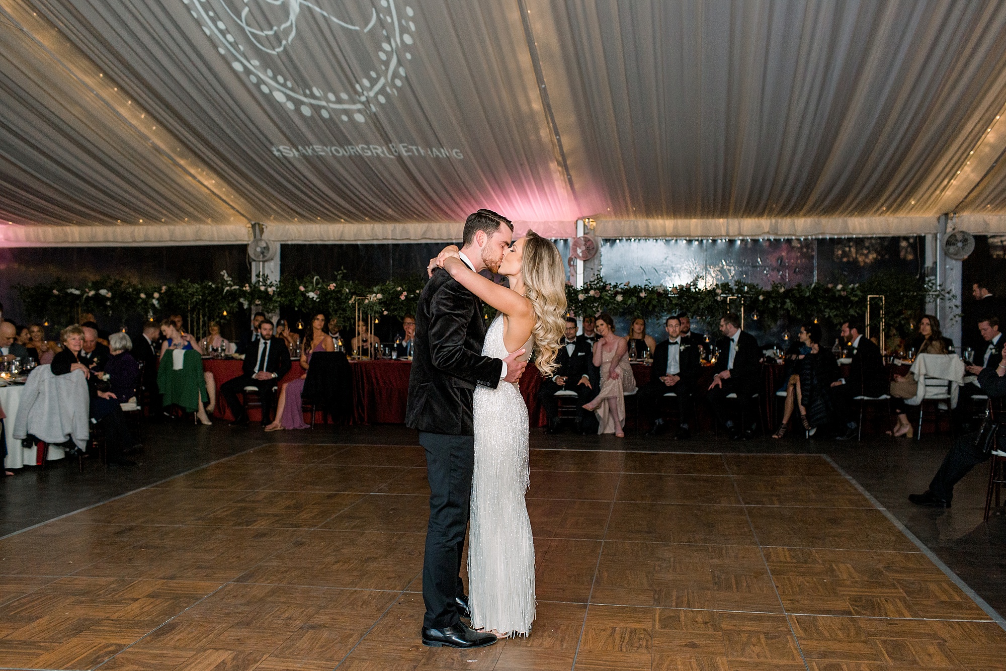newlyweds kiss during Tyler Gardens wedding reception dance 