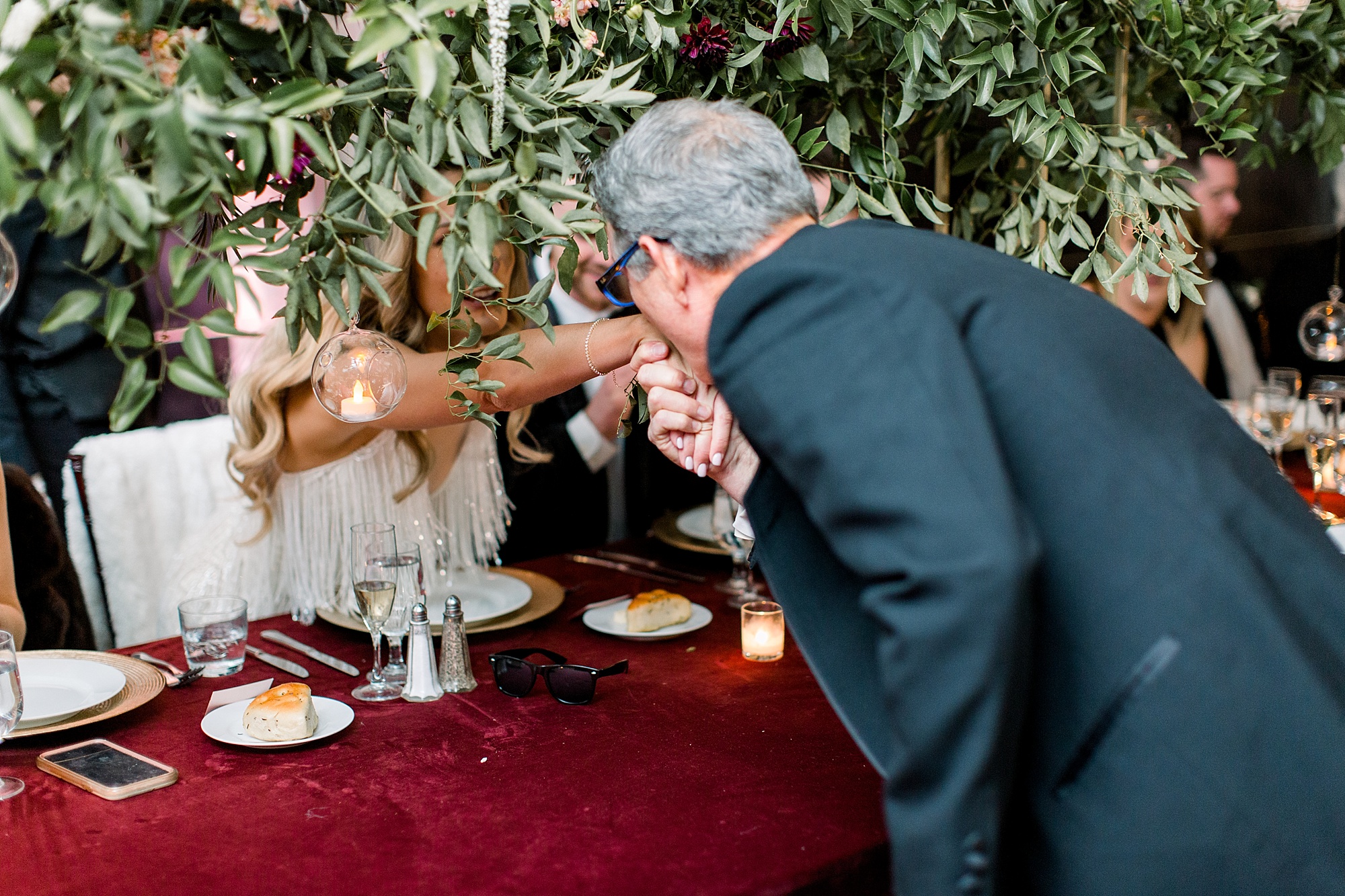 father kiss bride's hand after toast 