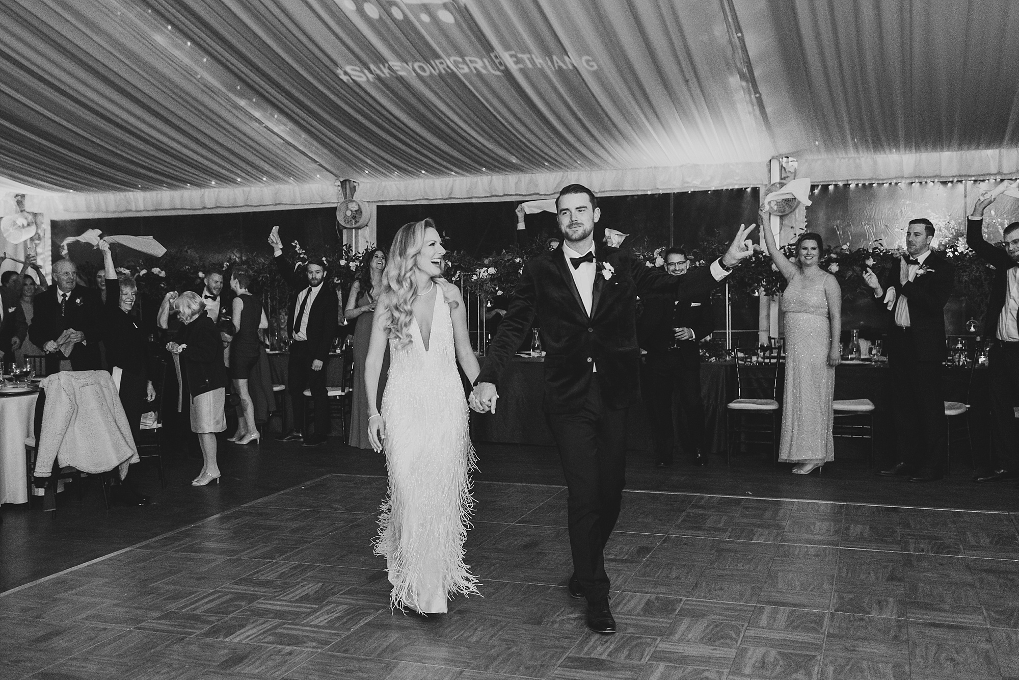 bride and groom walk onto dance floor at Tyler Gardens wedding reception