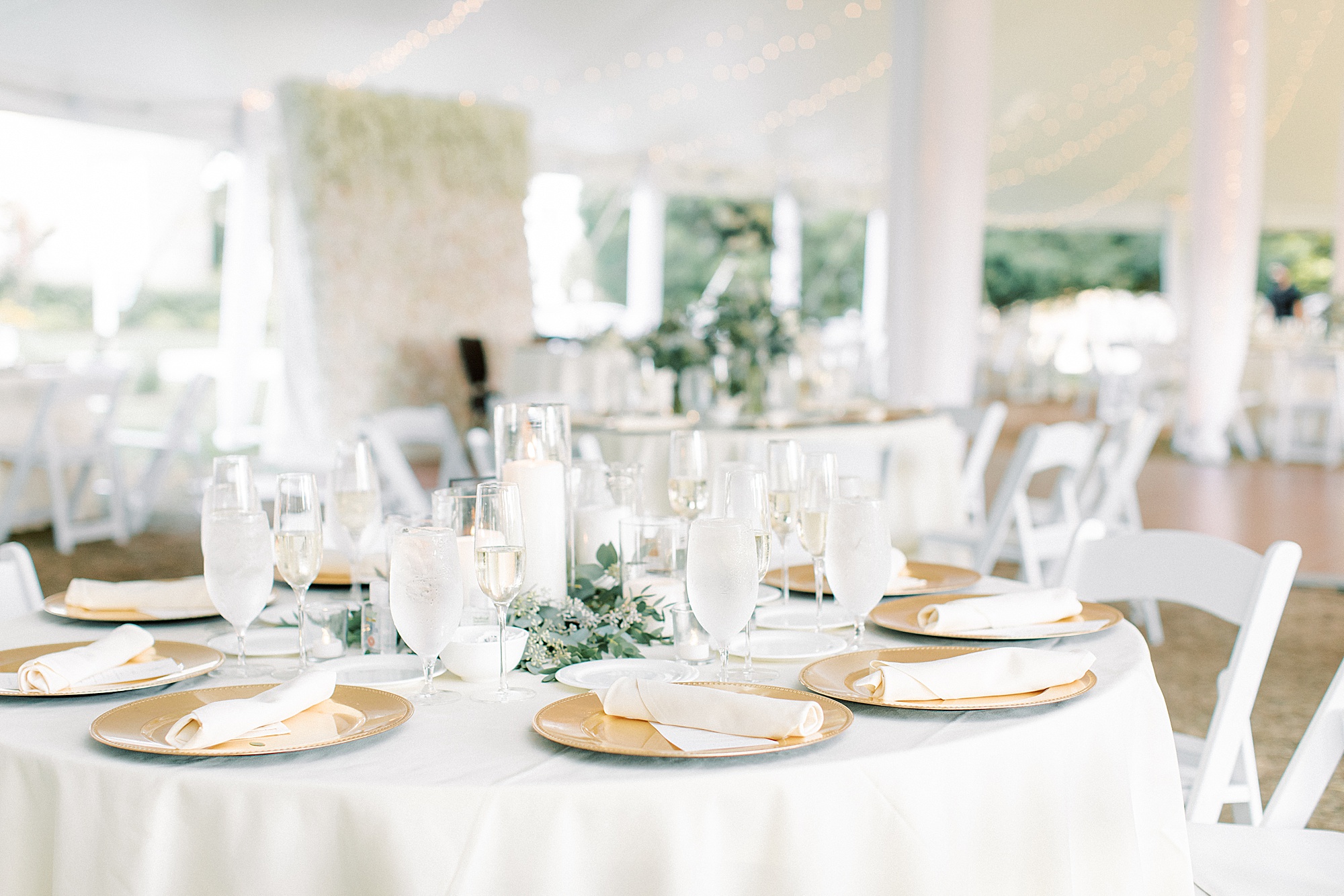 place settings with gold plates and white napkins at The Ballroom at Ellis Preserve