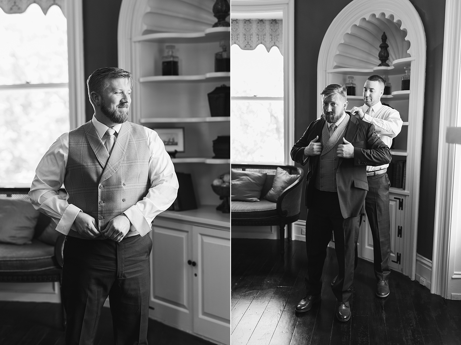 black and white portrait of groom getting into suit jacket at Bellevue Hall
