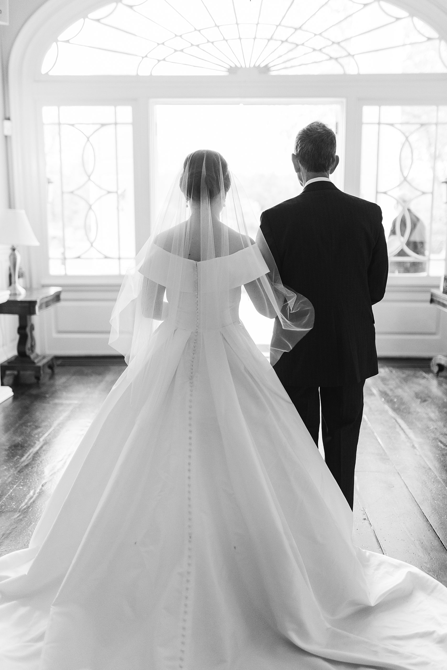 black and white portrait of bride with father inside Bellevue Hall