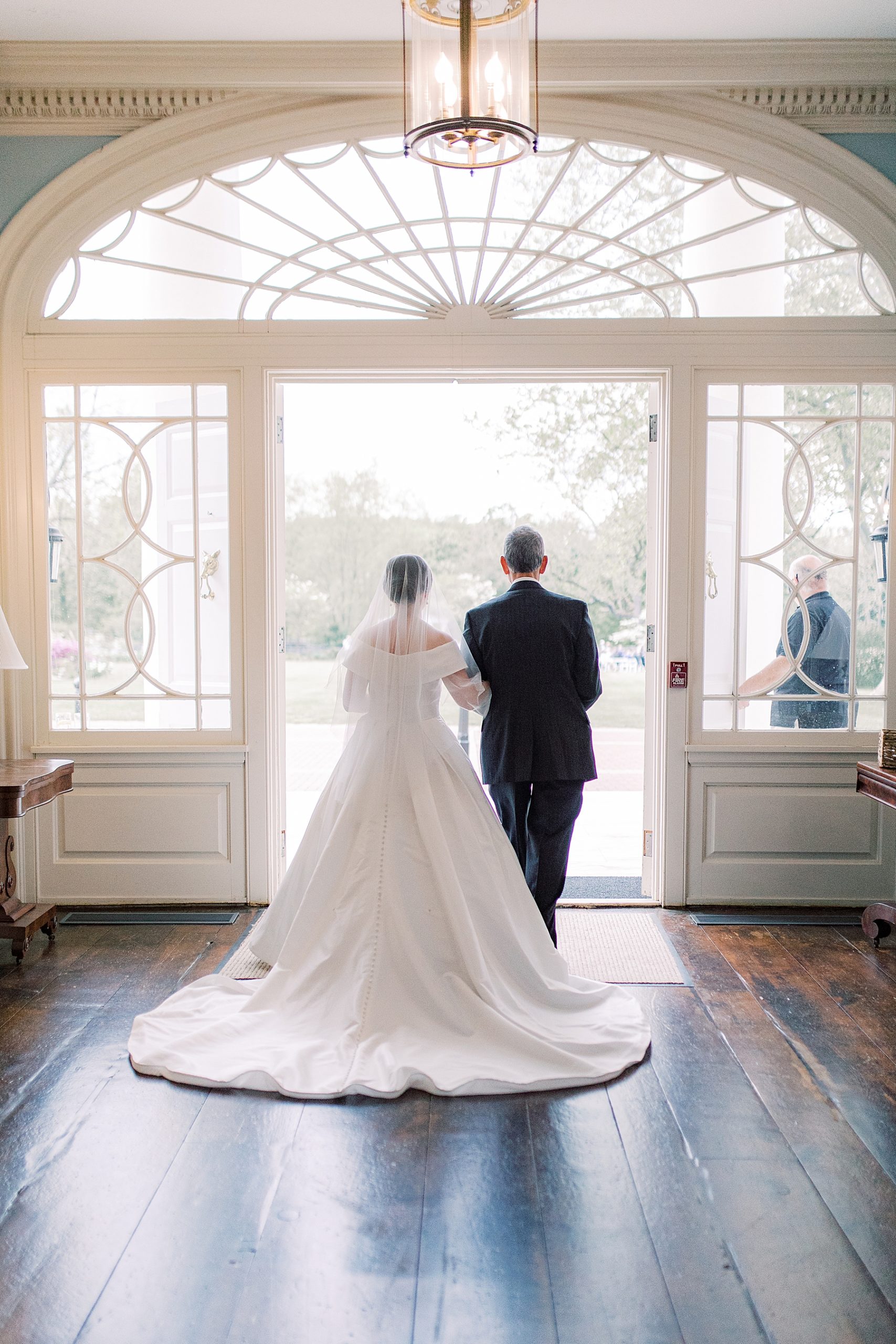 bride and father walk out of foyer at Bellevue Hall