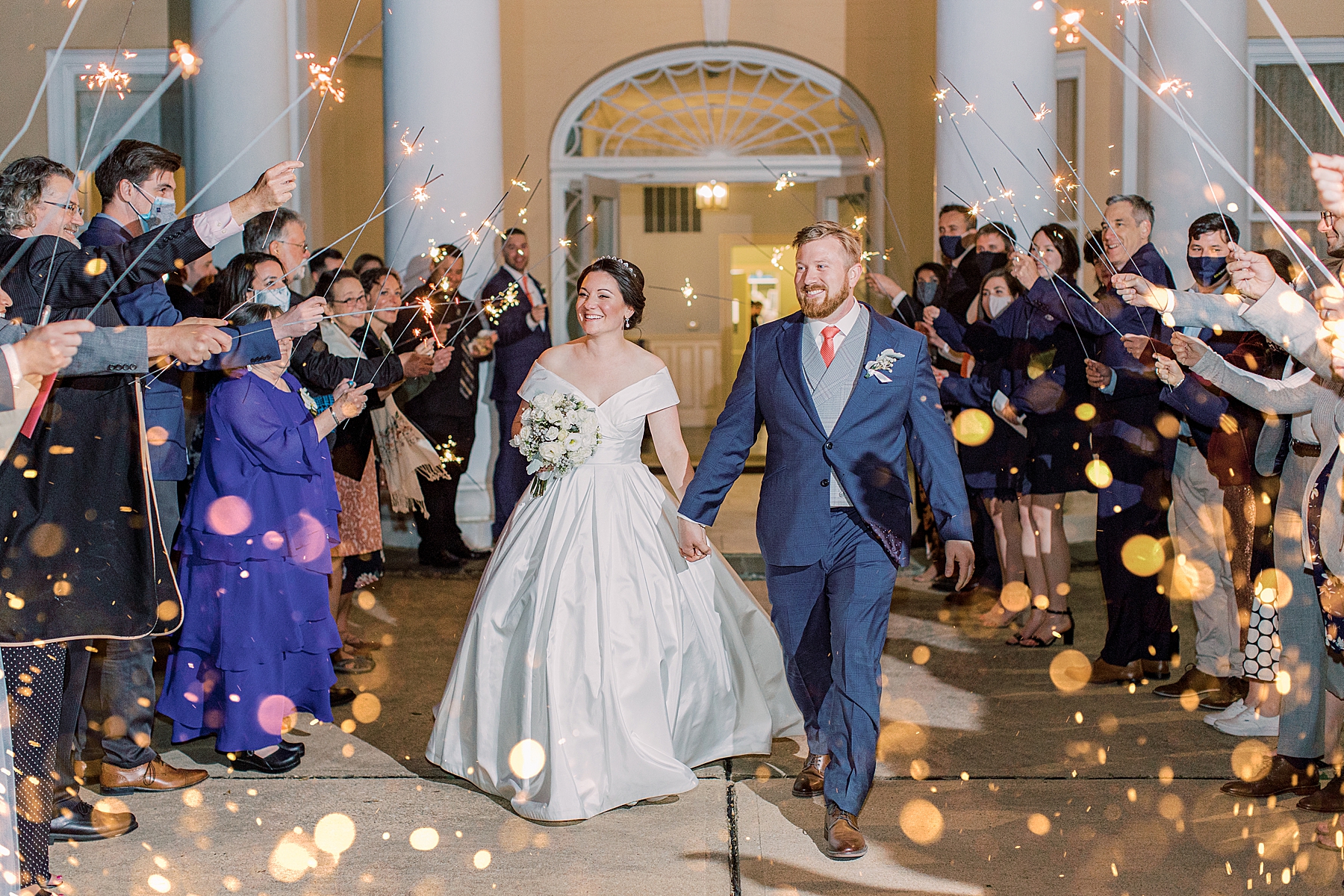 bride and groom leave wedding reception during sparkler exit in Delaware 
