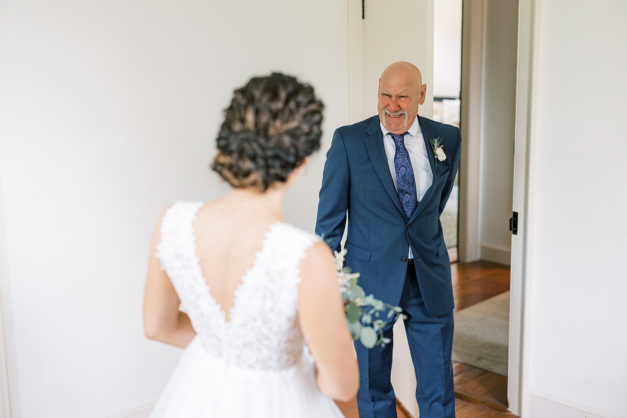 dad smiles seeing bride in wedding dress 