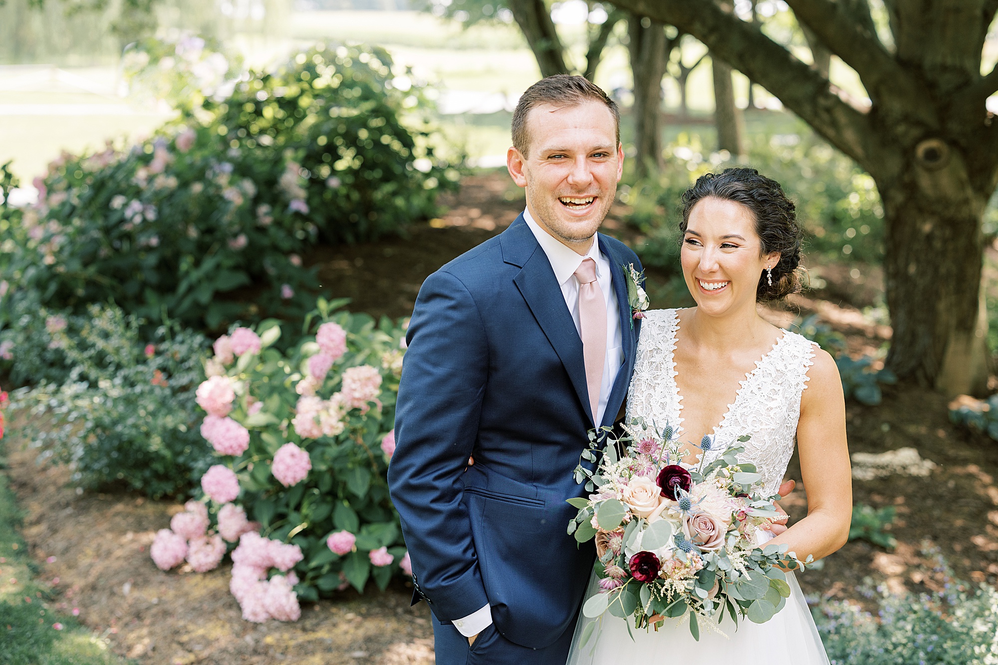newlyweds laugh together during summer wedding portraits at The Farm at Eagles Ridge 