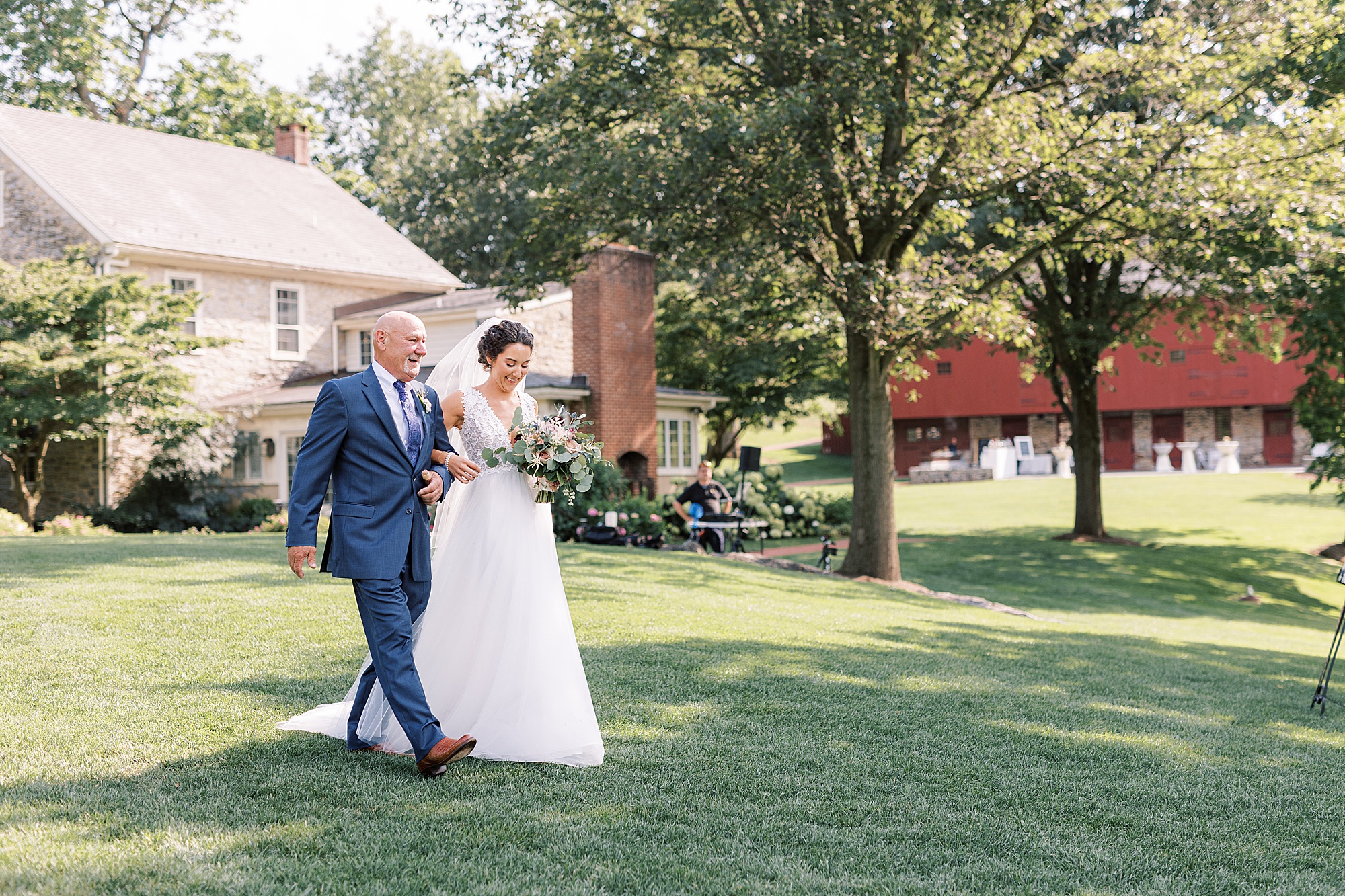 bride and father walk down lawn at The Farm at Eagles Ridge 