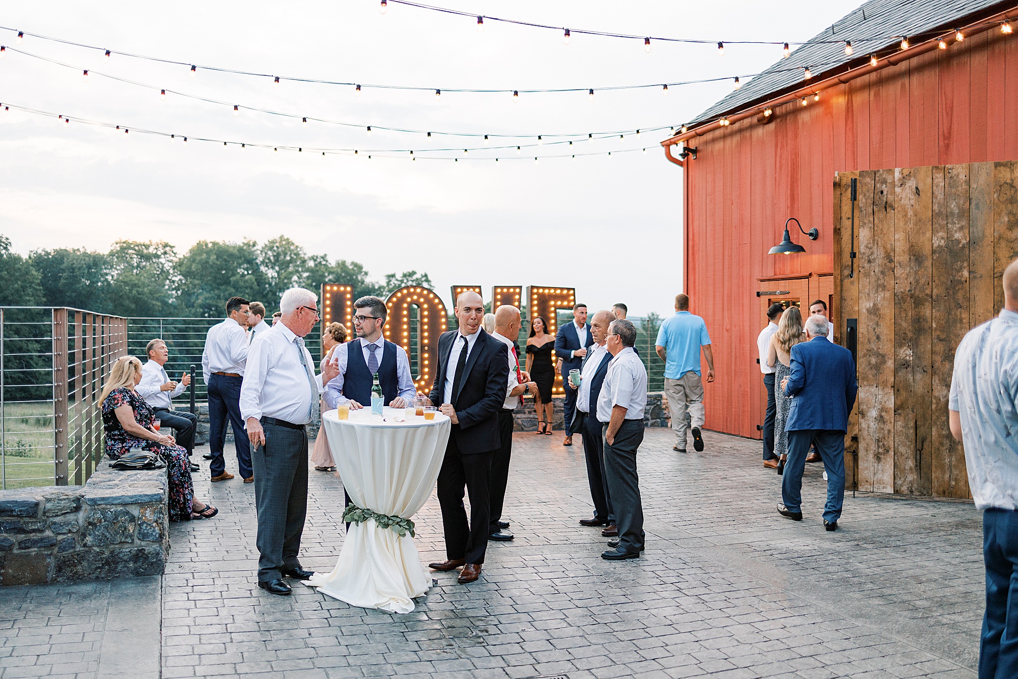 guests mingle outside on patio at The Farm at Eagles Ridge