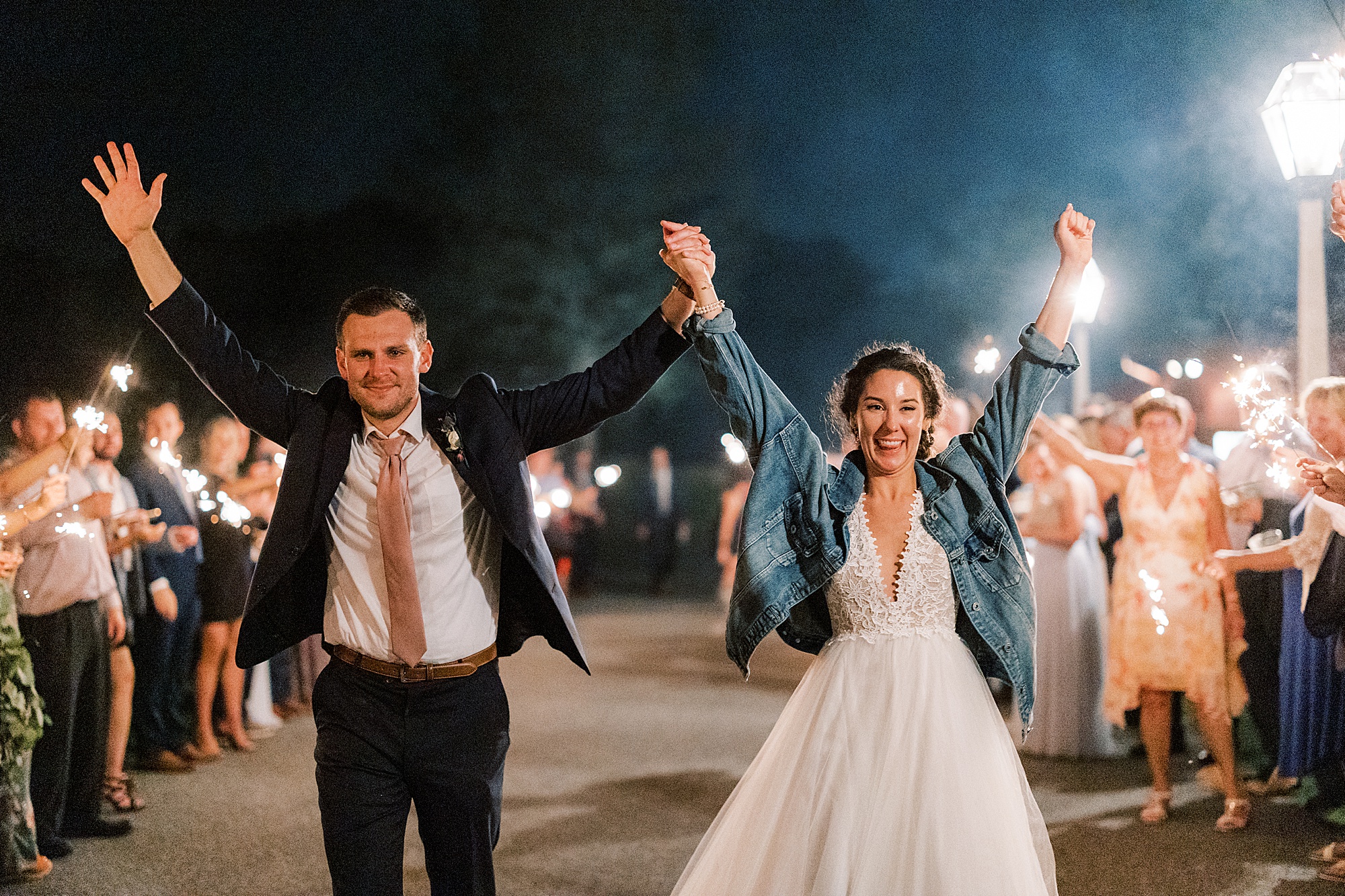 bride and groom cheer leaving through sparkler exit 