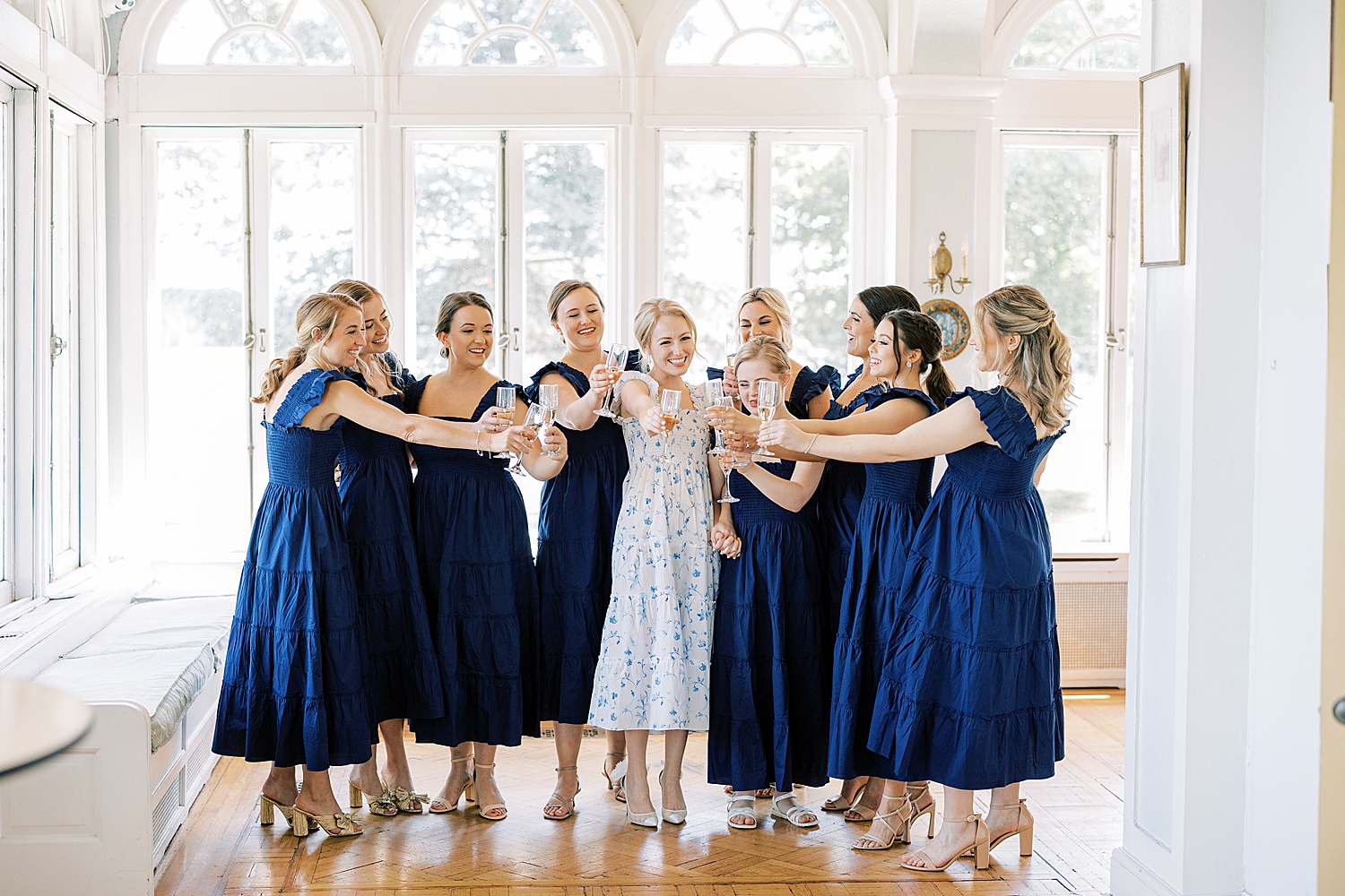 bride and bridesmaids toast champagne before Glen Foerd on the Delaware wedding 