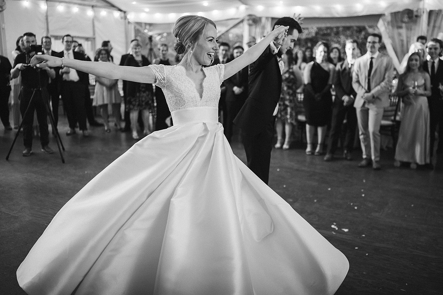 groom twirls bride on dance floor at Philadelphia PA wedding reception