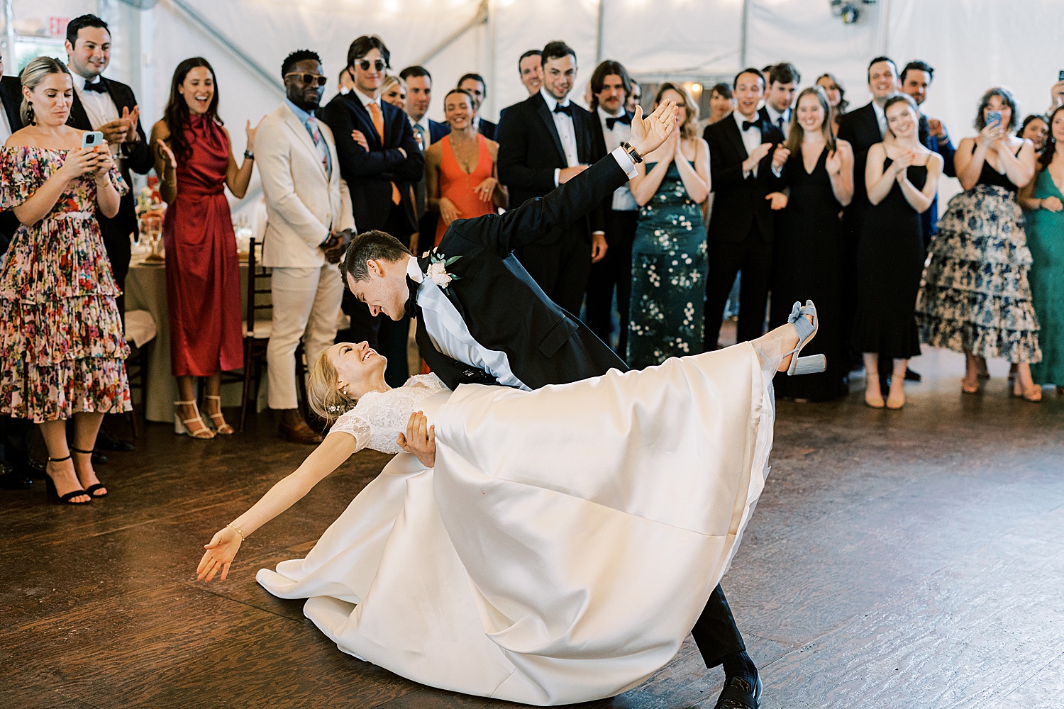 groom dips bride backwards on dance floor during Philadelphia PA wedding reception