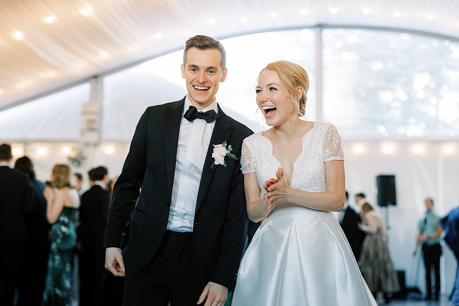 newlyweds smile and laugh together during Philadelphia PA wedding reception