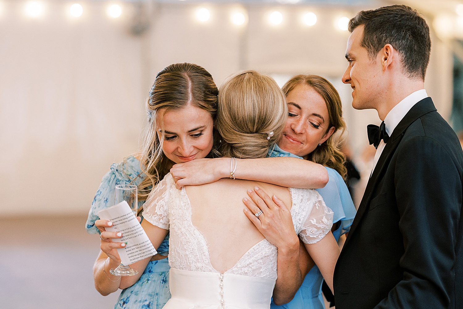 bridesmaids hug bride after toast during Philadelphia PA wedding reception