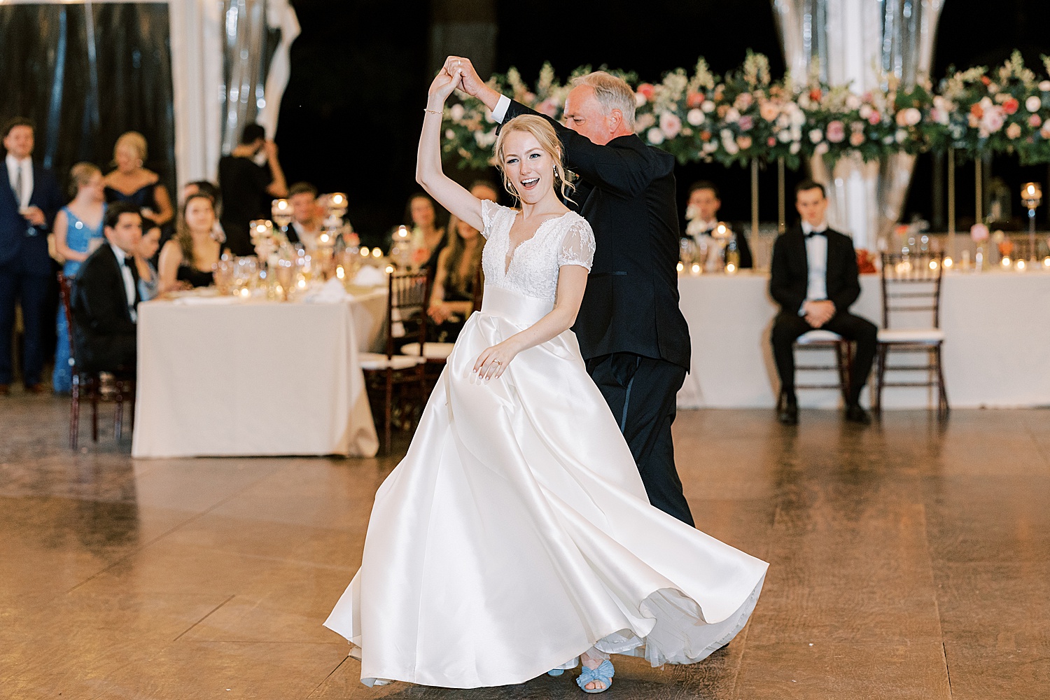 father twirls bride during Philadelphia PA wedding reception