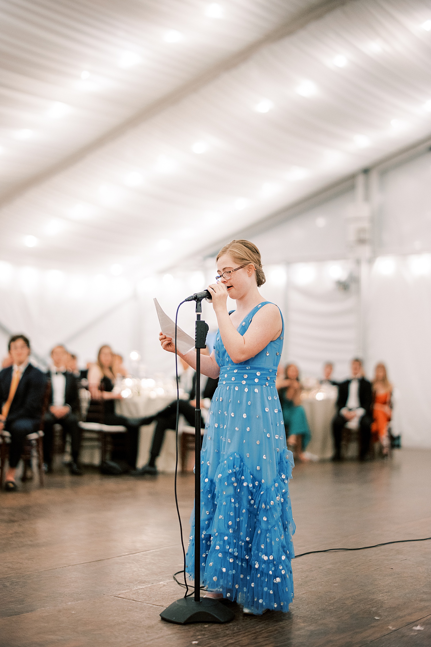 woman in blue dress reads speech during Philadelphia PA wedding reception