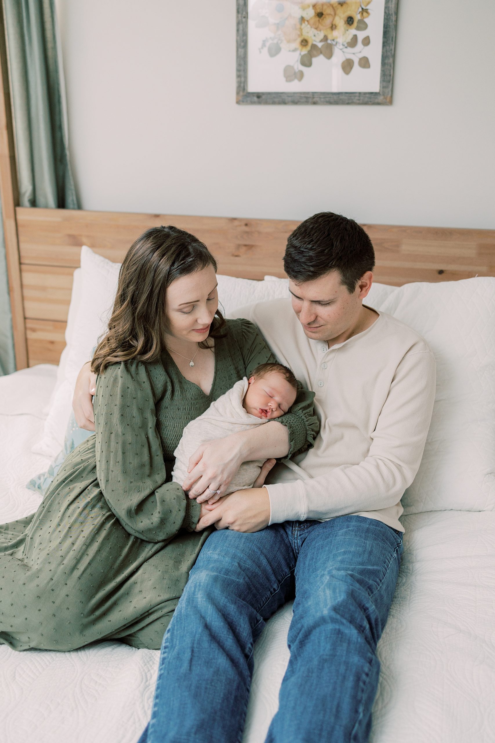 parents sit with son on bed during Media PA newborn session