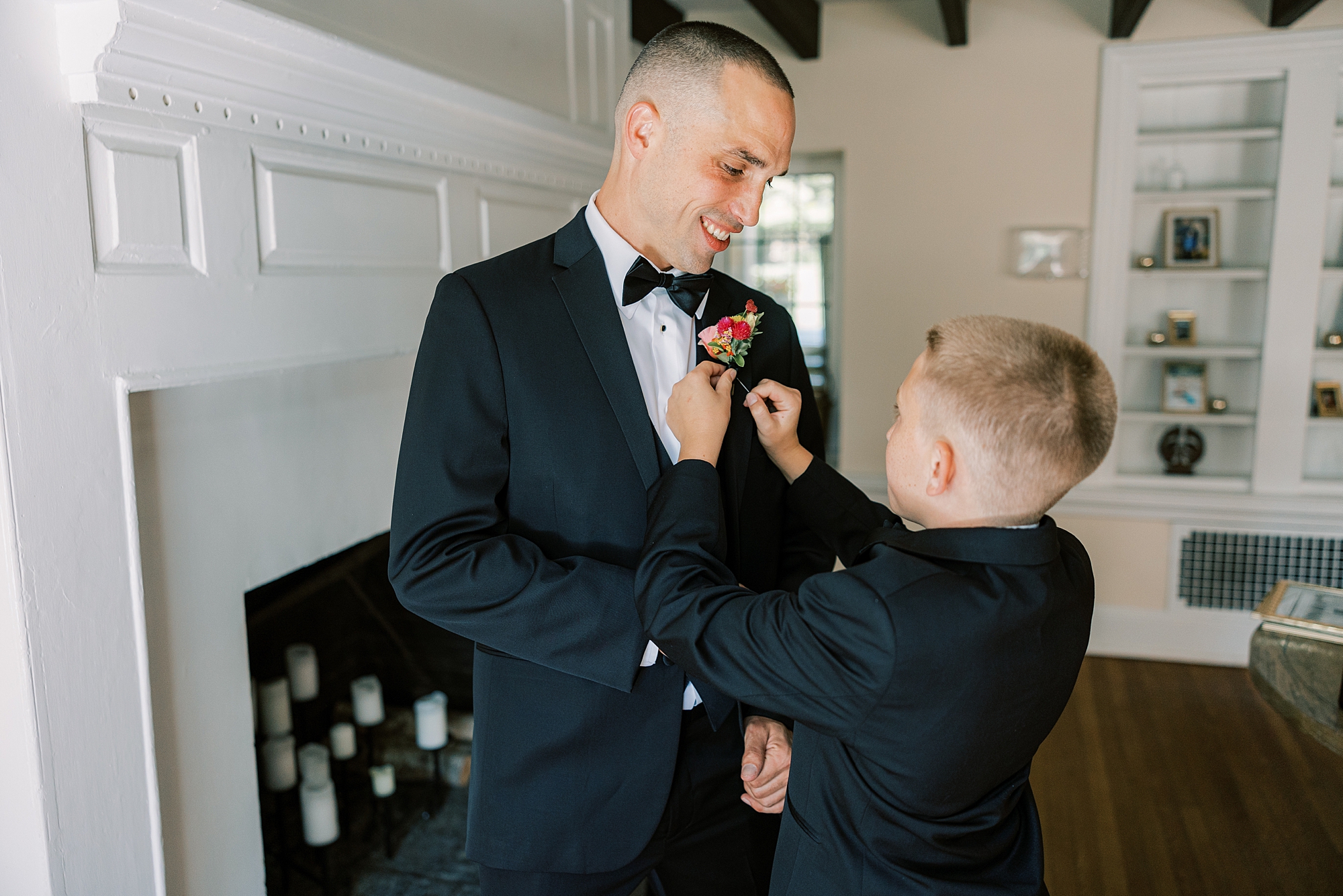groom's son puts on flowers for dad 