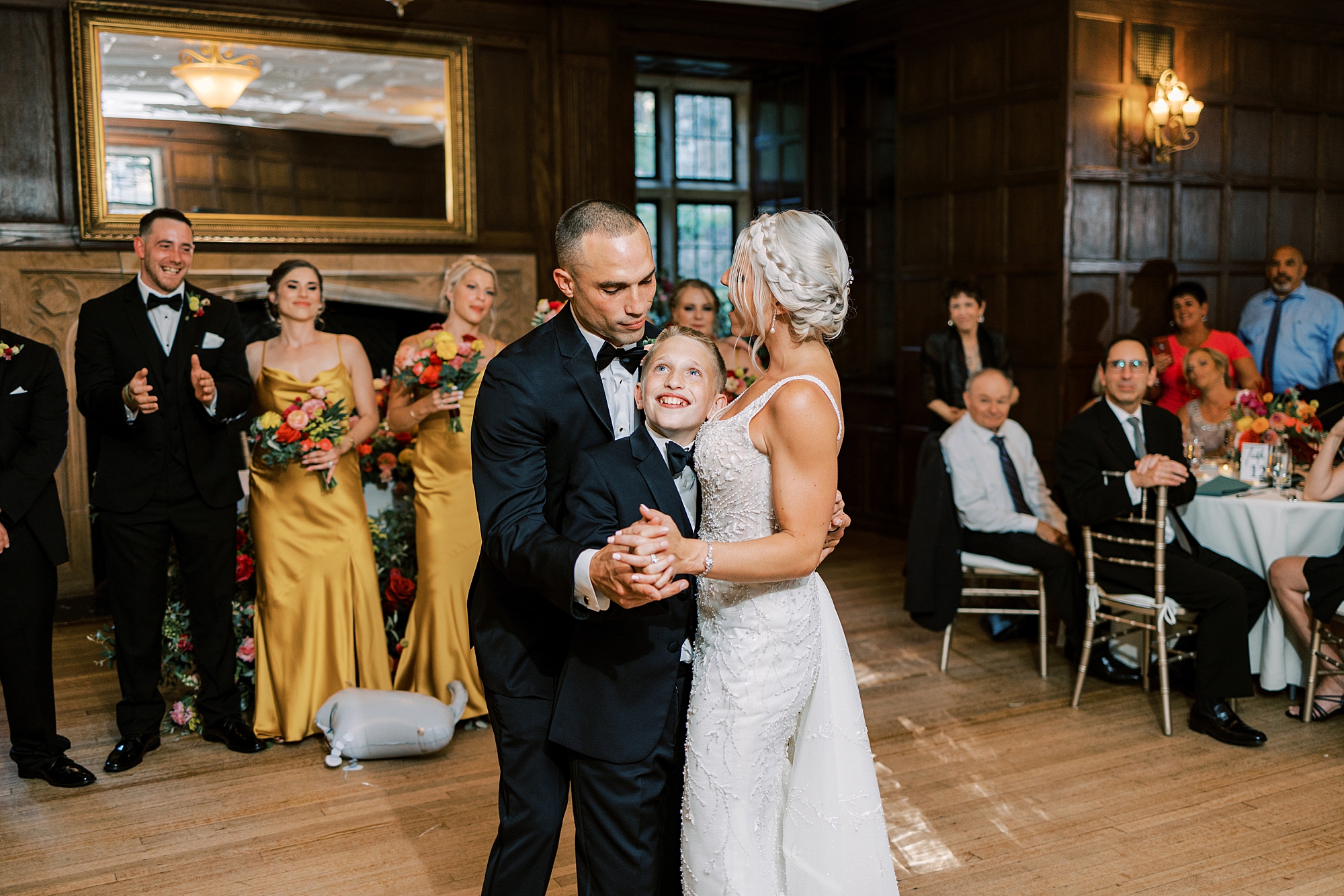 bride and groom dance with son at PA wedding reception 