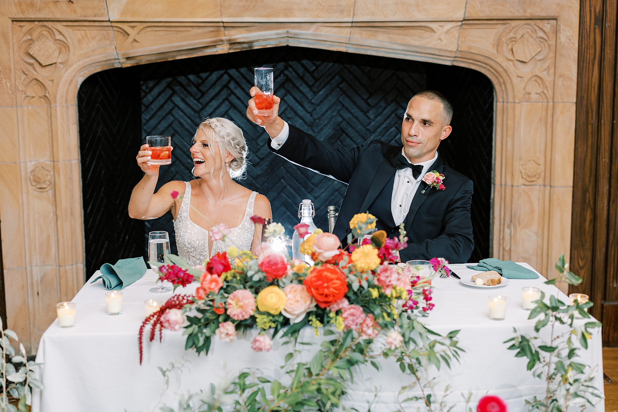 newlyweds lift cocktail during toasts at Parque Ridley Creek wedding reception 