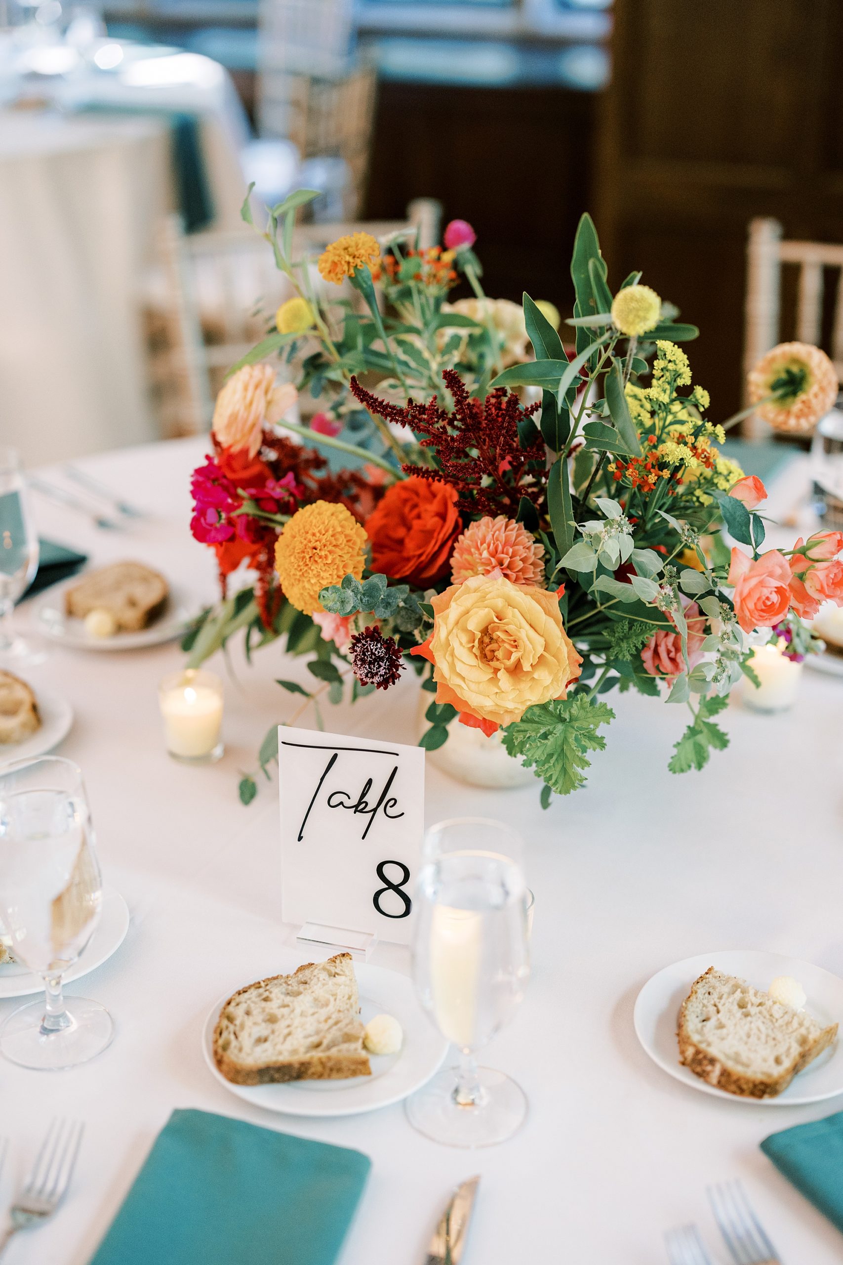 wedding reception with orange and pink flowers 