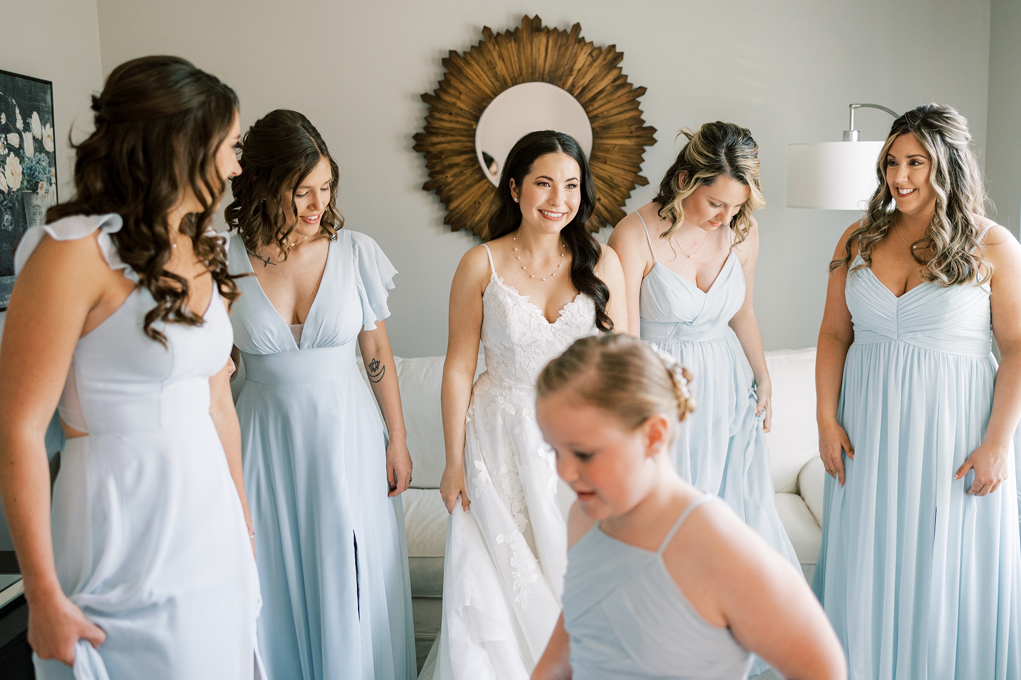 bride and bridesmaids in light bleu gowns prepare in bridal suite at French Creek Golf Club