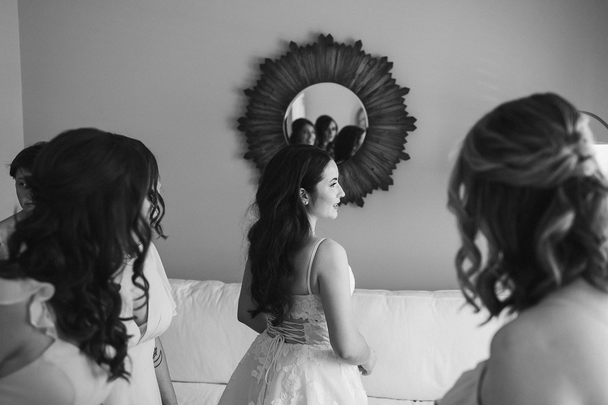 bridesmaids look at the back of wedding gown 