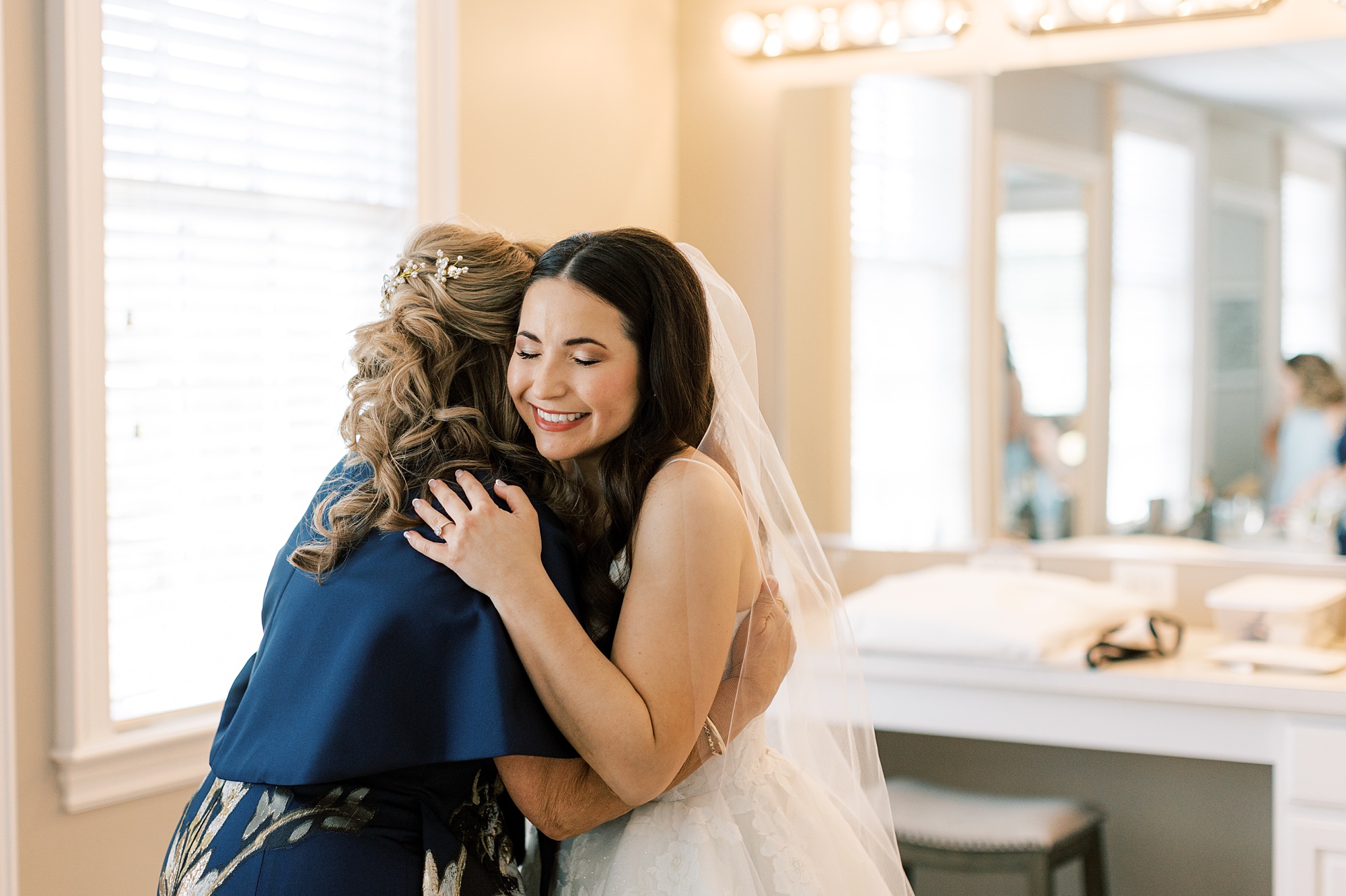 bride and mother hug in bridal suite at French Creek Golf Club