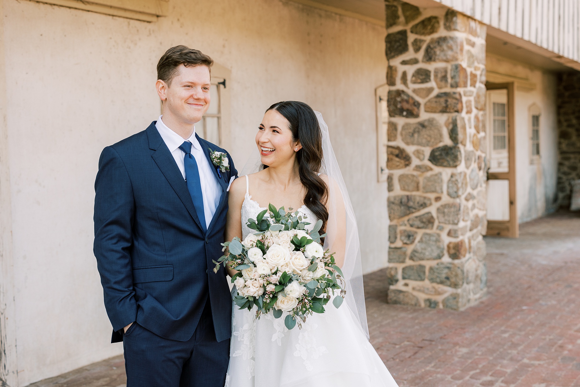 bride smiles up at groom during portraits at French Creek Golf Club
