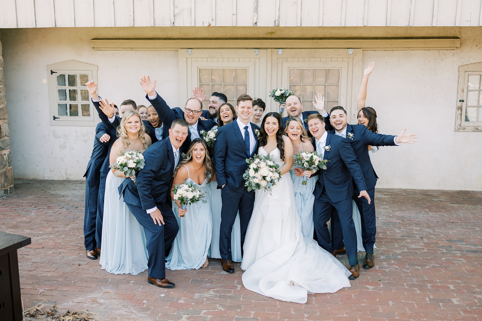newlyweds and wedding party cheer during portraits by French Creek Golf Club