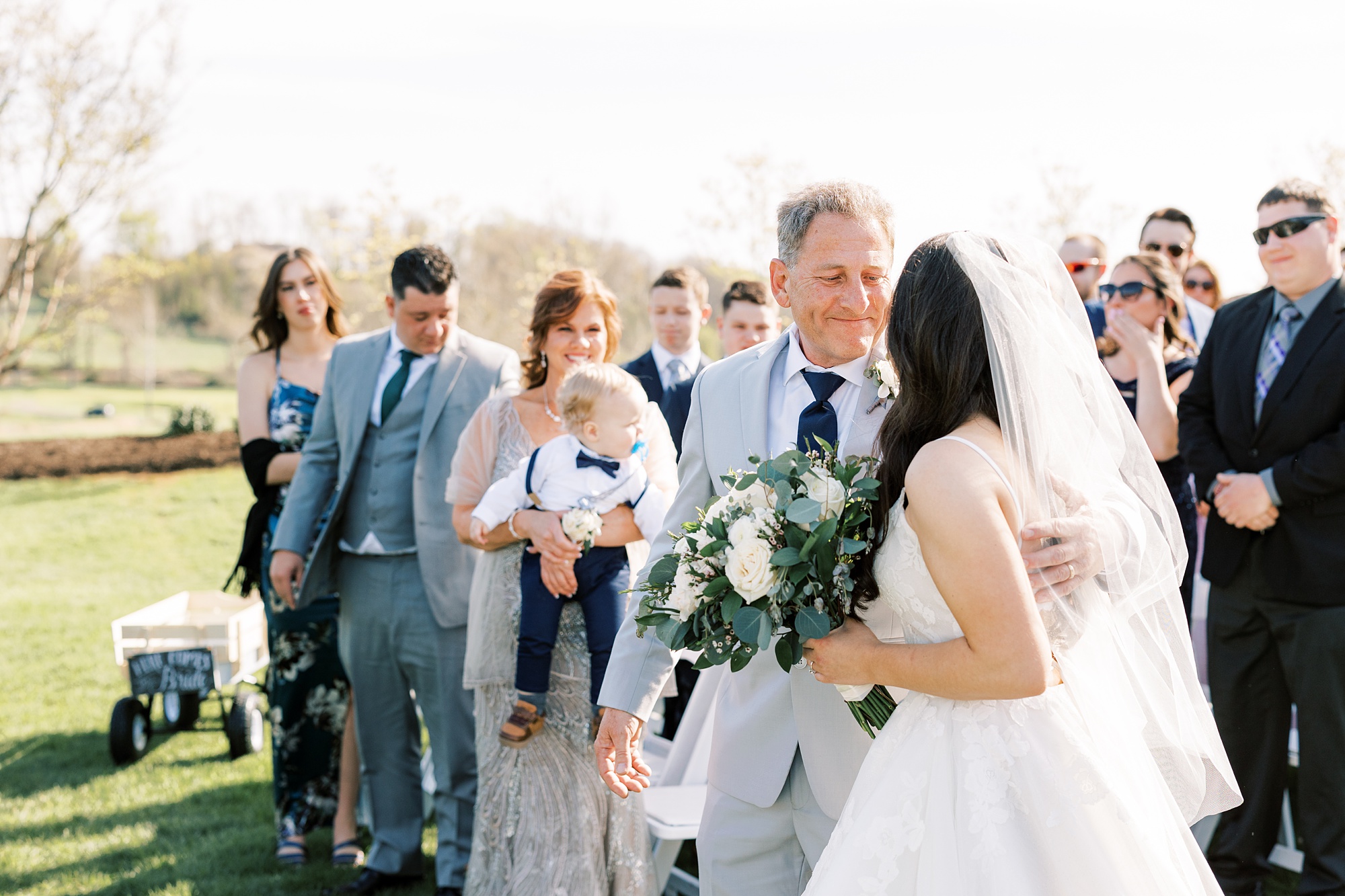 father smiles at bride during outdoor wedding ceremony on the lawn of French Creek Golf Club