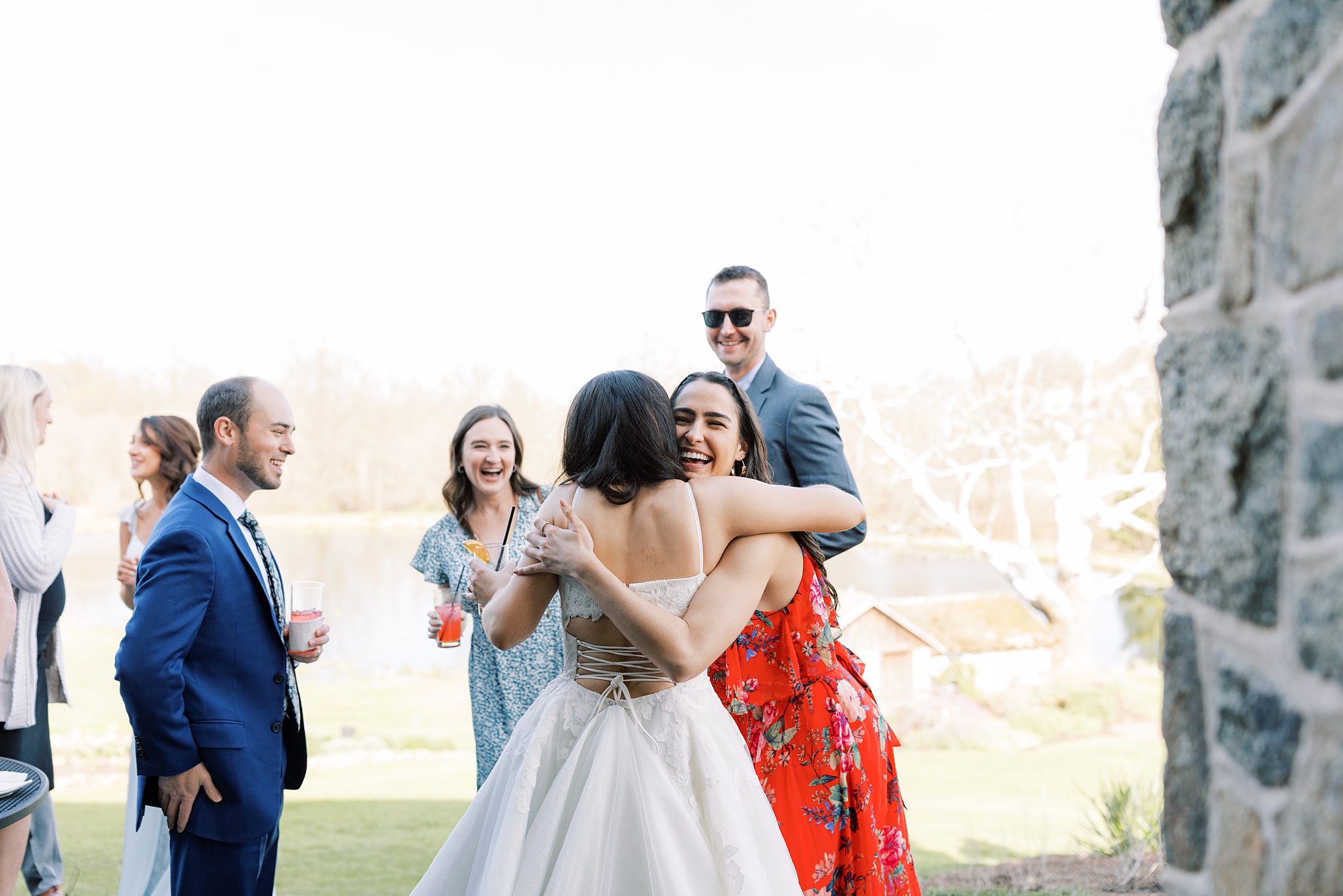guests hug bride during cocktail hour 