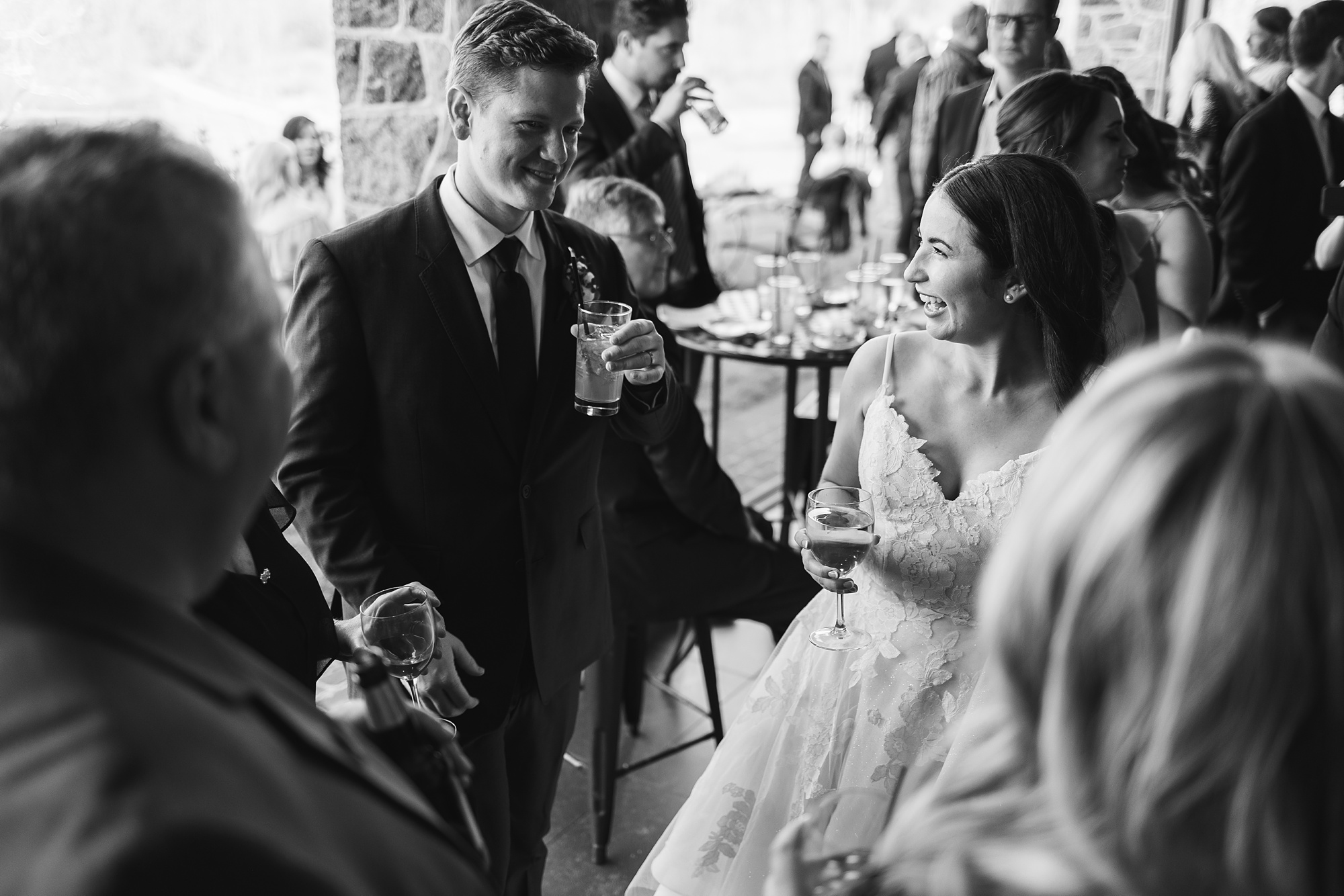 bride and groom smile with guests during cocktail hour at French Creek Golf Club 