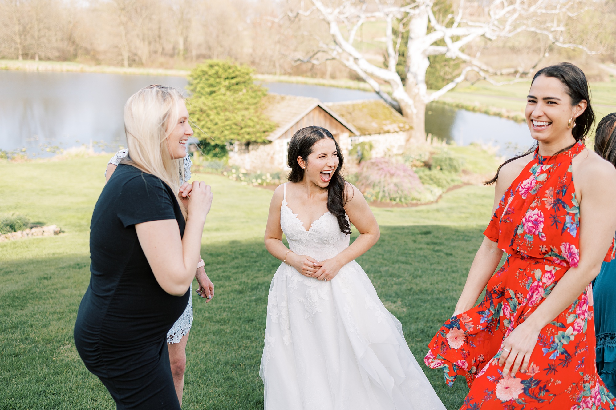 bride laughs with guests during cocktail hour